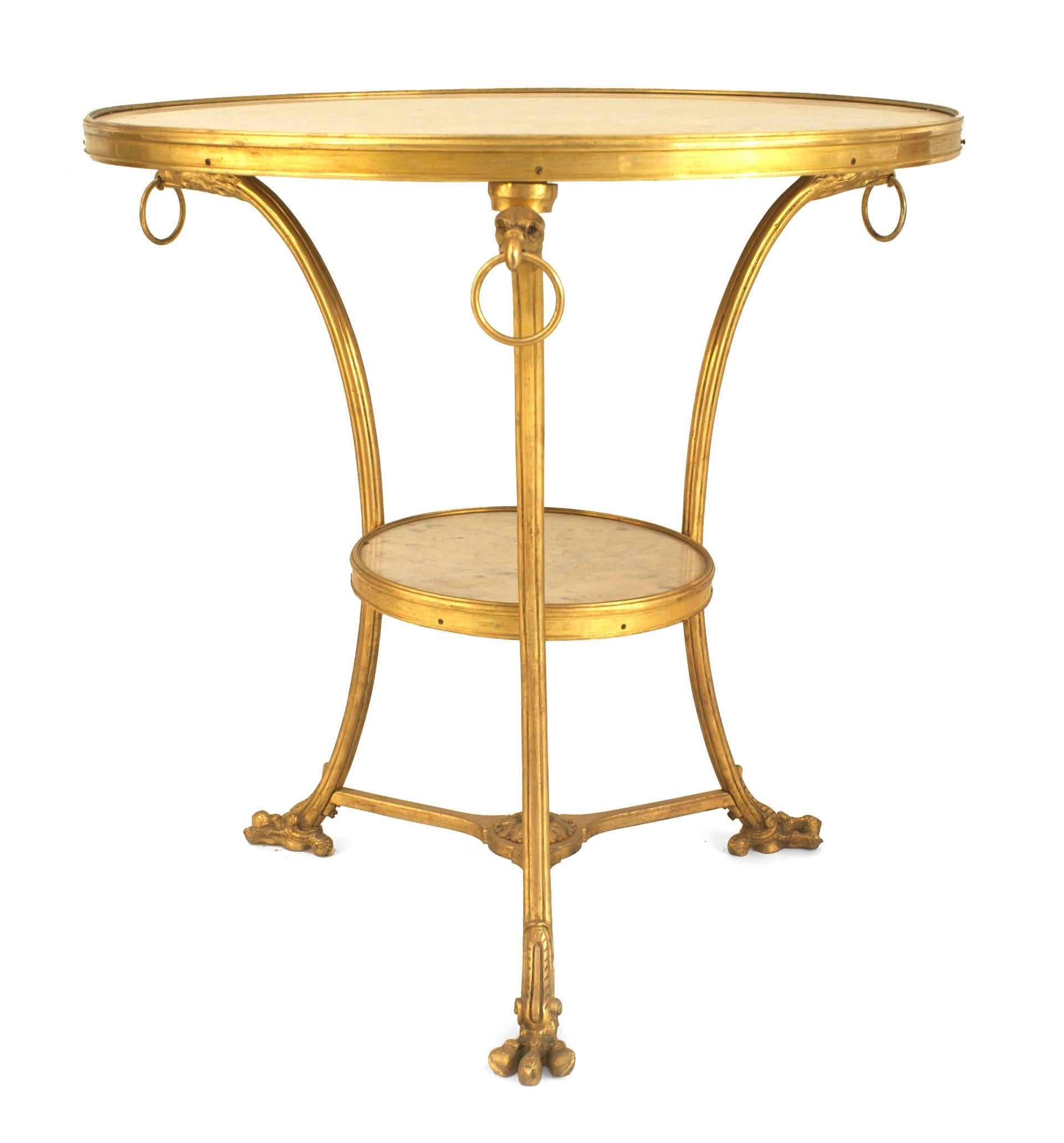 Two French Empire style bronze doré three legged round Gueridon end tables with eagle head design and white marble top and shelf (priced each).
  
