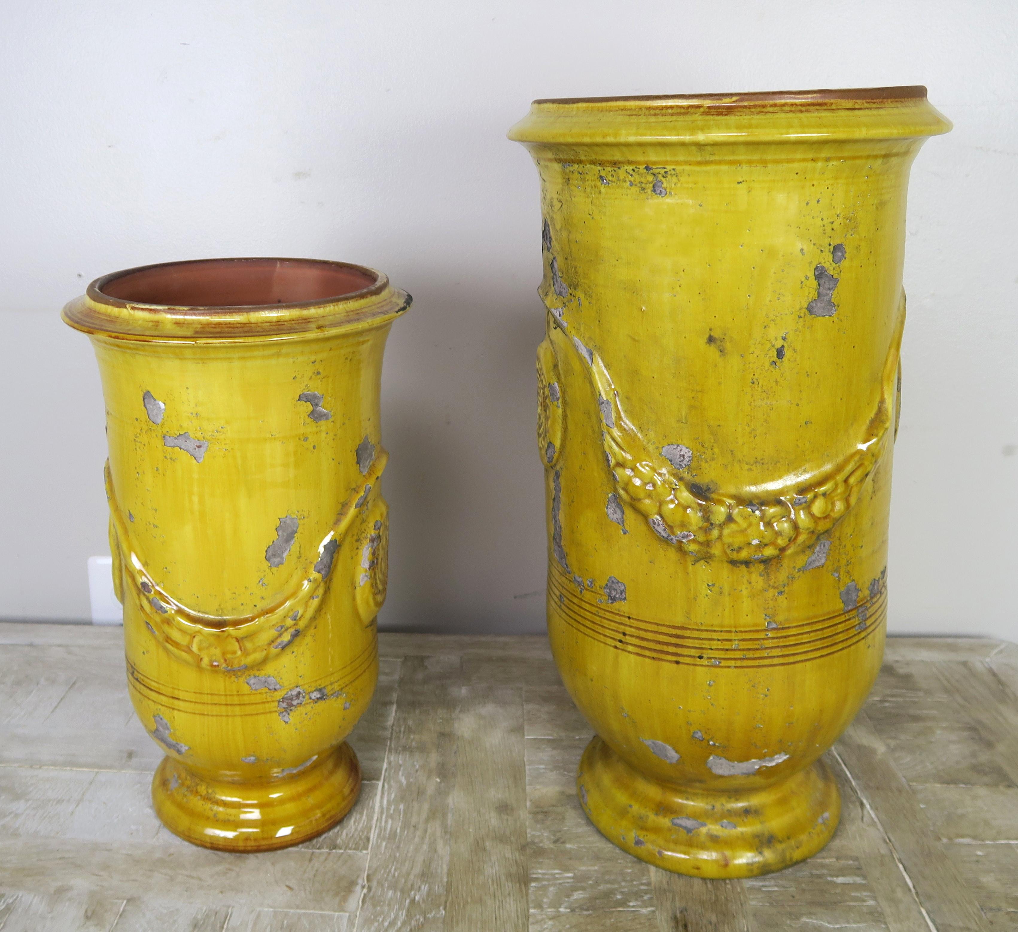 Two French yellow glazed ceramic urns. Stamped by maker.
Measures: Large 11
