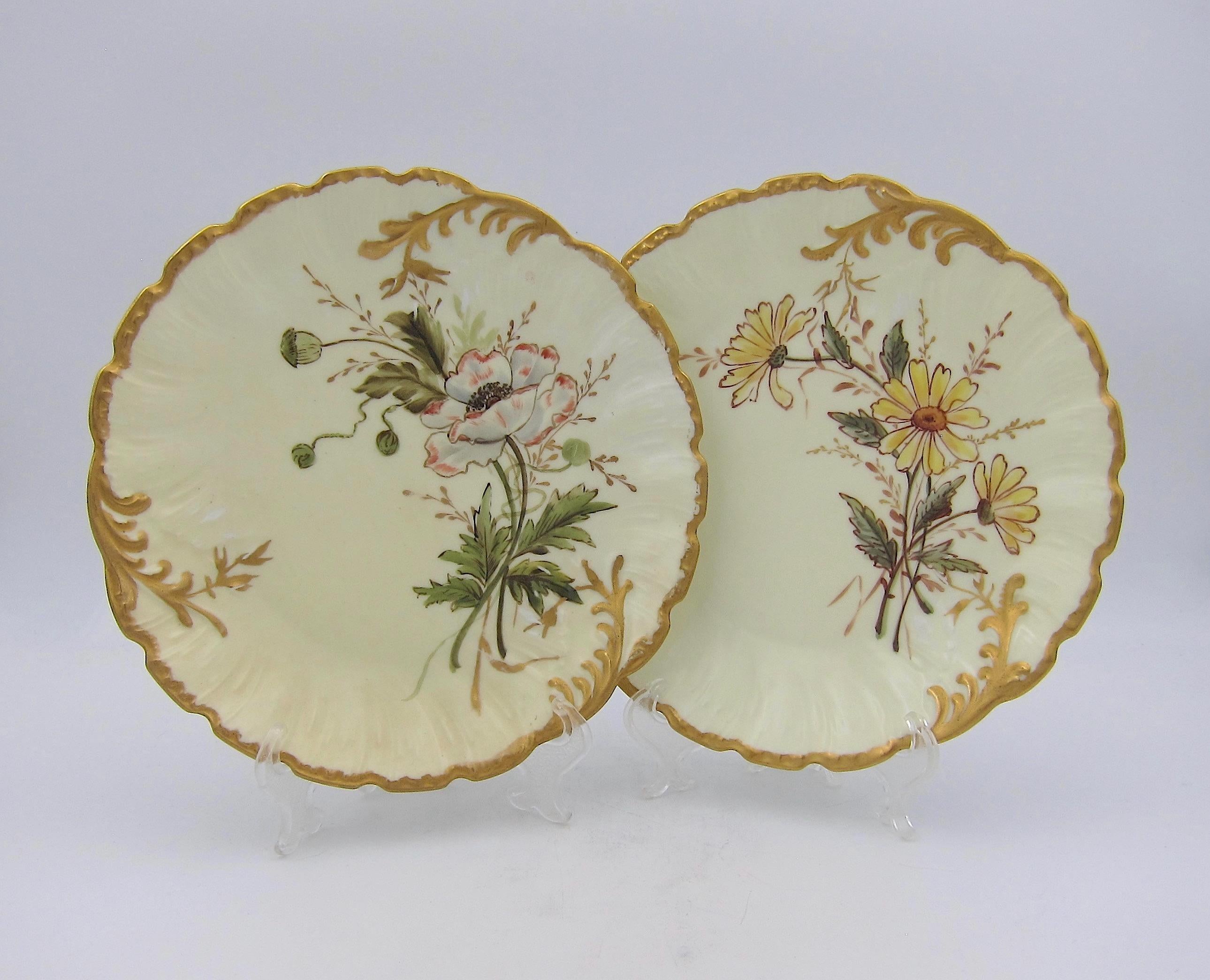 Two late 19th century porcelain plates by Martial Redon, hand-painted by Bawo & Dotter's Elite Works in Limoges, France. Each antique plate is skillfully decorated with naturalistic, hand-painted floral sprays with gilt highlights and scalloped