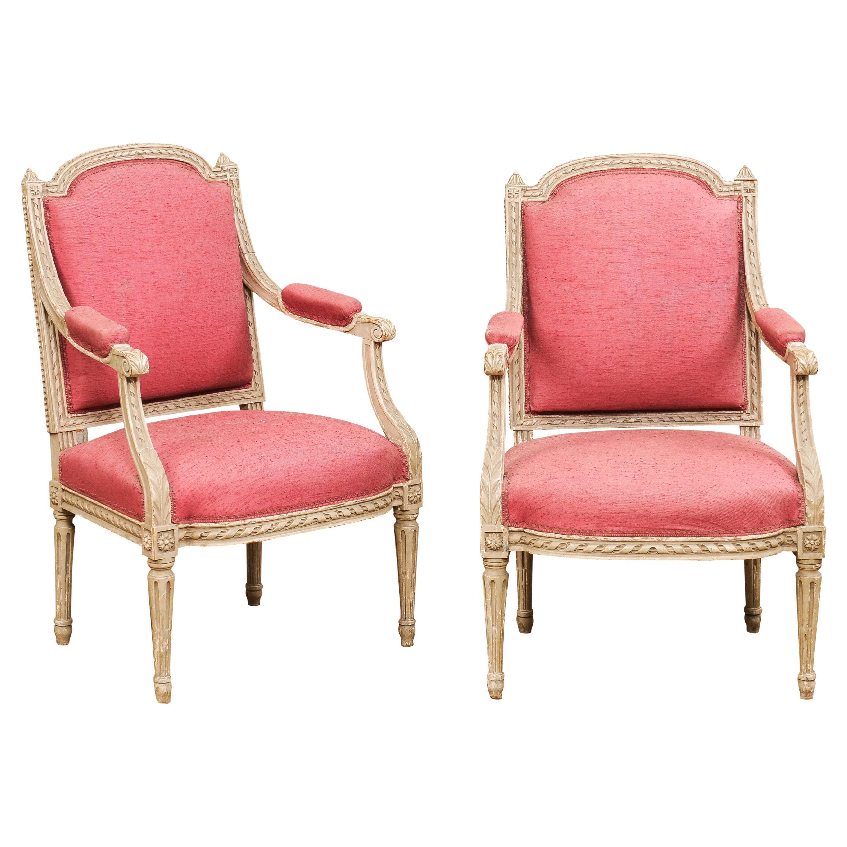 Two French Louis XVI Style Painted Armchairs with Richly Carved Décor, Sold Each For Sale