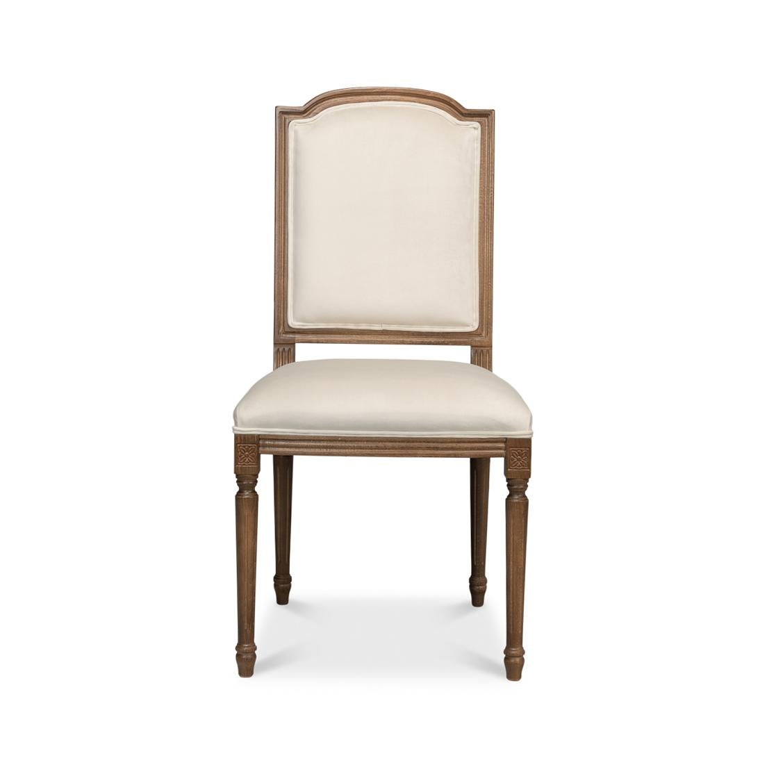 This fine chair is a true nod to the classic French Provincial design, crafted with detailed attention to bring an air of elegance to your dining room. The graceful wooden frame boasts a rich, warm finish, complementing the cream-colored upholstery