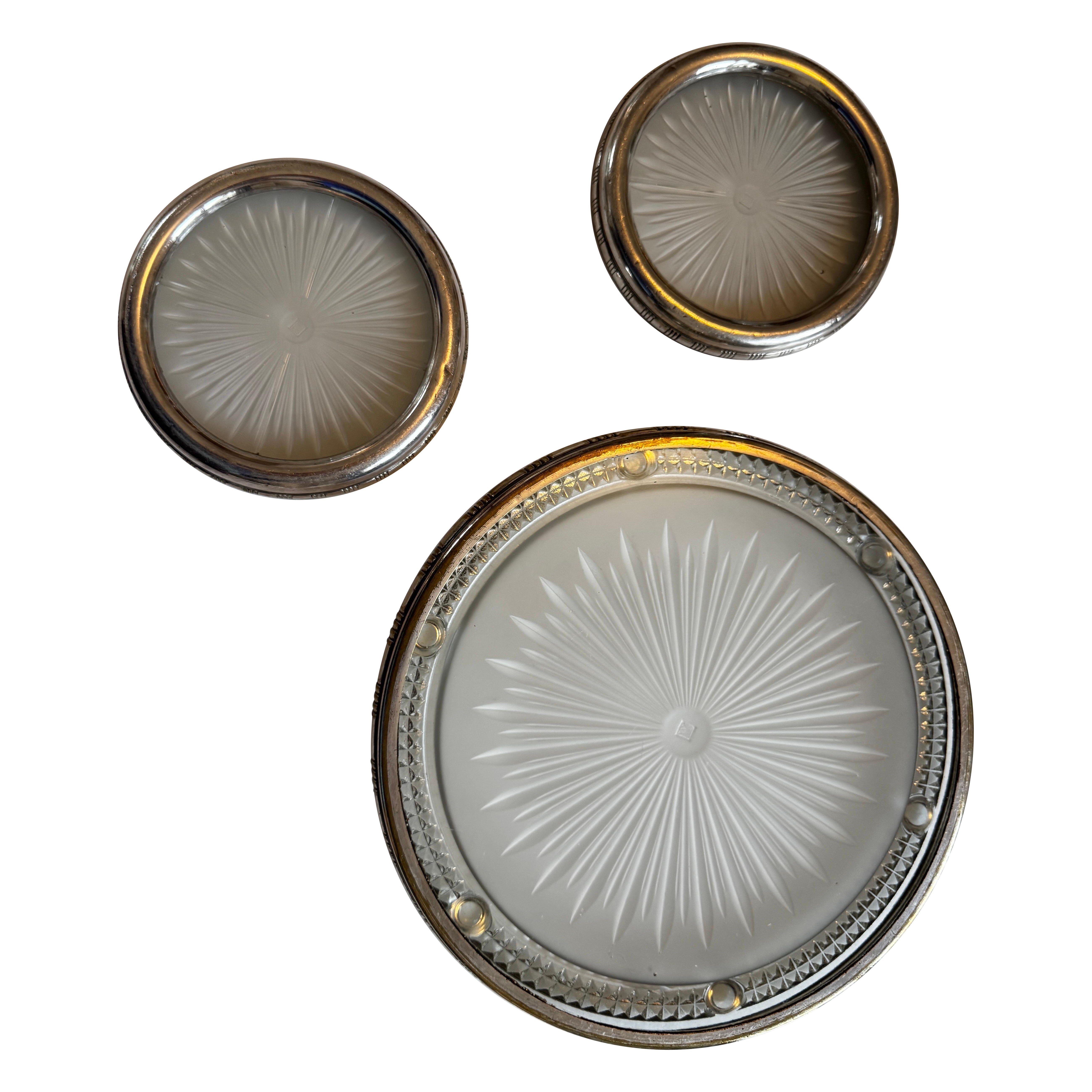 These three table accessories are made of thick glass made by a famous French company part of Holophane France between the 1920’s and 1940’s, making decorative items. 

The maker was called Verrerie des Andelys and their VA signature is visible in