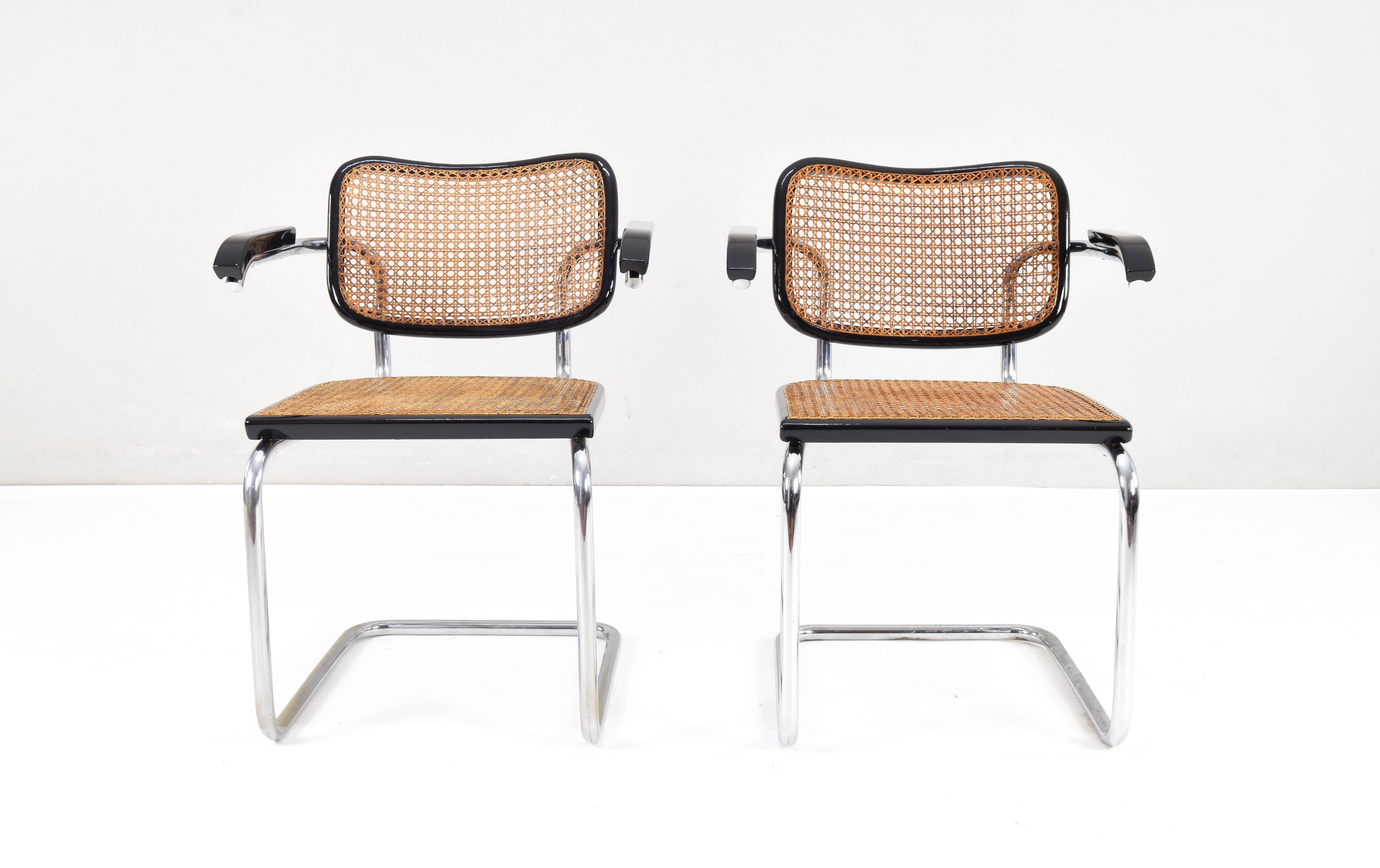 Beautiful and iconic set of two Cesca chairs, model B64, edition with armrests, manufactured by MYC Gavina, a subsidiary of Gavina Italia in Spain in the 1960s. These chairs are part of a high-quality edition.

Chromed tubular structure with worn