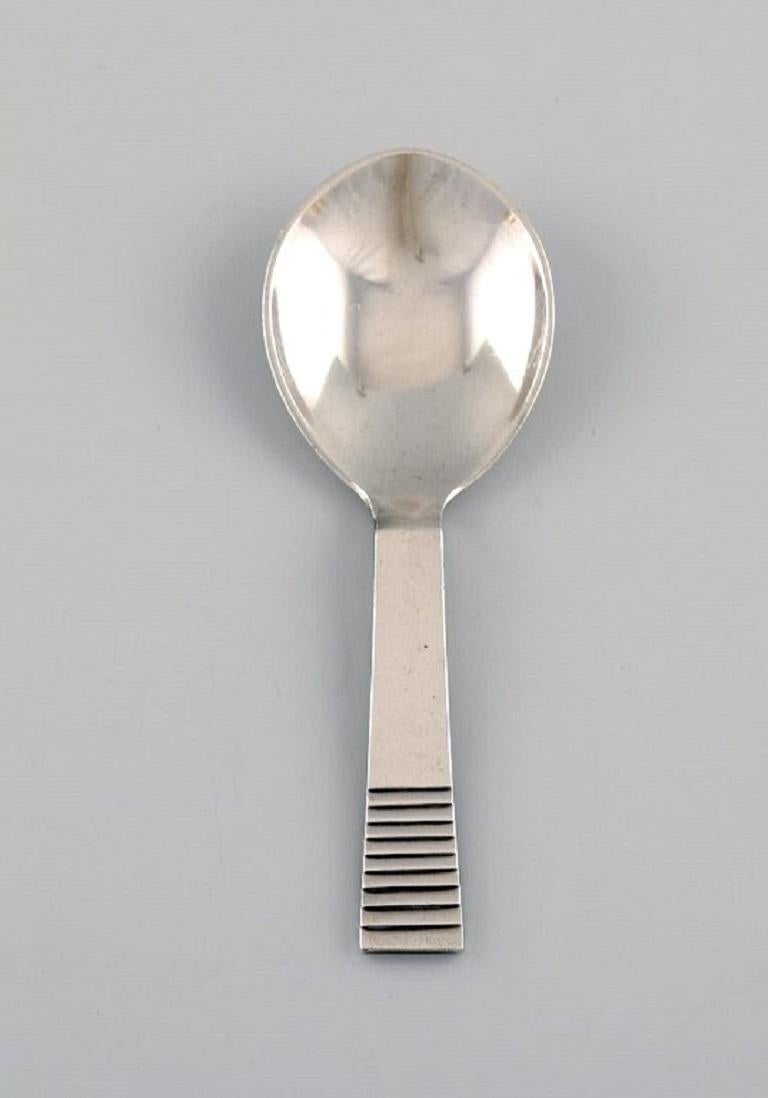 Two Georg Jensen Parallel / Relief jam spoons in sterling silver. 
1930s.
Measure: length: 10.7 cm.
In excellent condition.
Stamped.
Our skilled Georg Jensen silversmith / goldsmith can polish all silver and gold so that it appears new. The