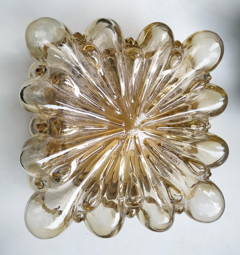 One of two wonderful vintage handmade amber bubble glass flushmount.
Germany, 1960s.
Lamp sockets: 2x E27 (US E26).
The color of lights is not 100% identical.

 