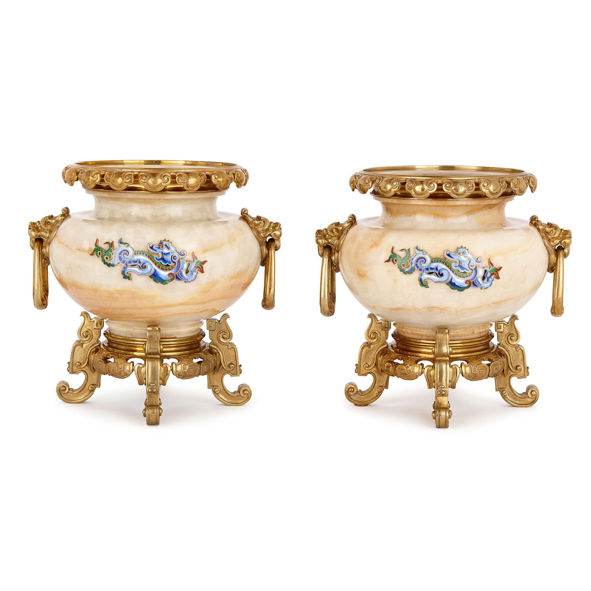 These beautiful vases are designed in the chinoiserie style. Derived from the French word ‘chinois’ for Chinese, chinoiserie was a European style that was inspired by Chinese and East Asian art and design. These urns were crafted by Henri Journet &