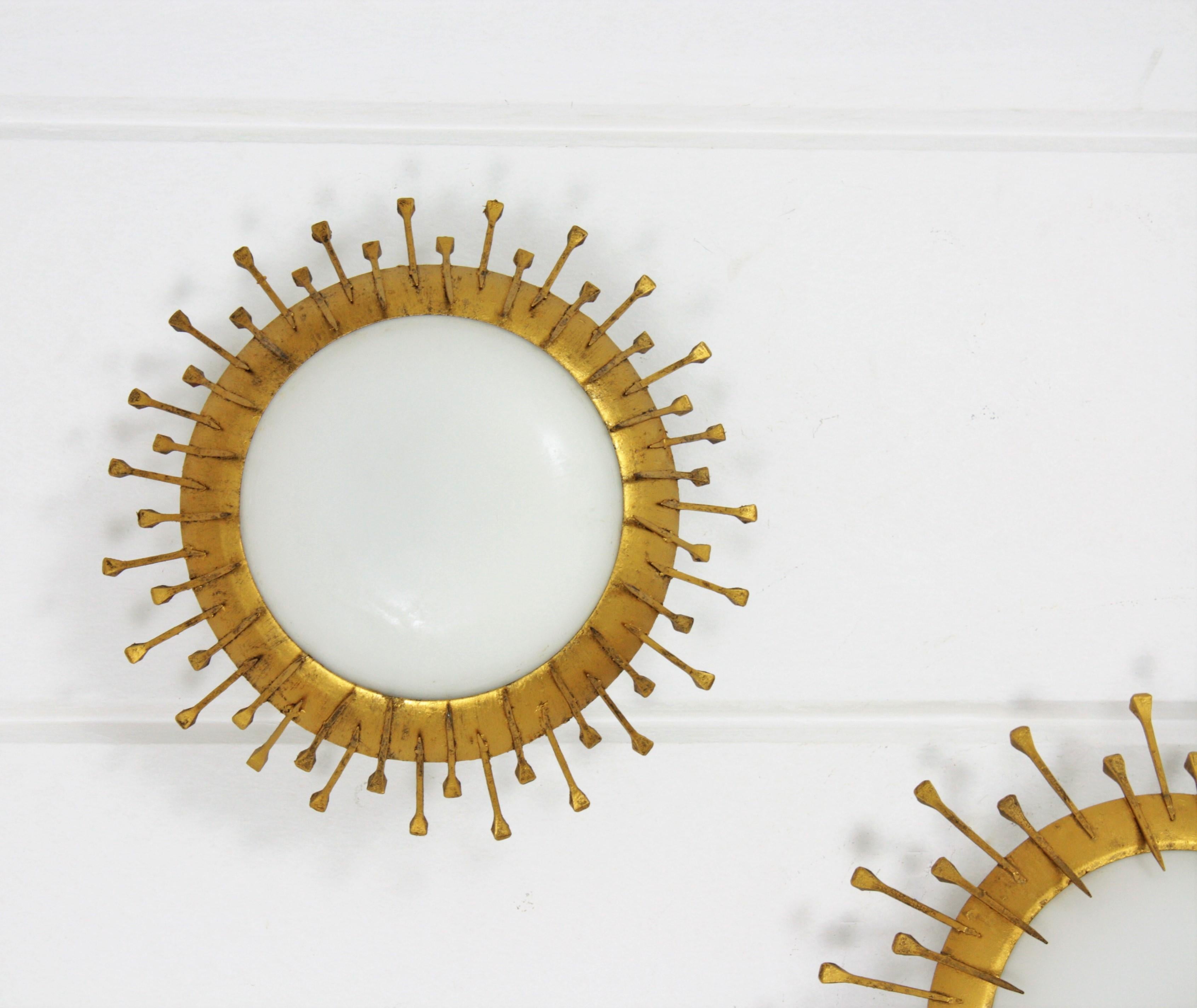 French Two Gilt Iron Milk Glass Sunburst Light Fixtures with Nail Details, France 1940s
