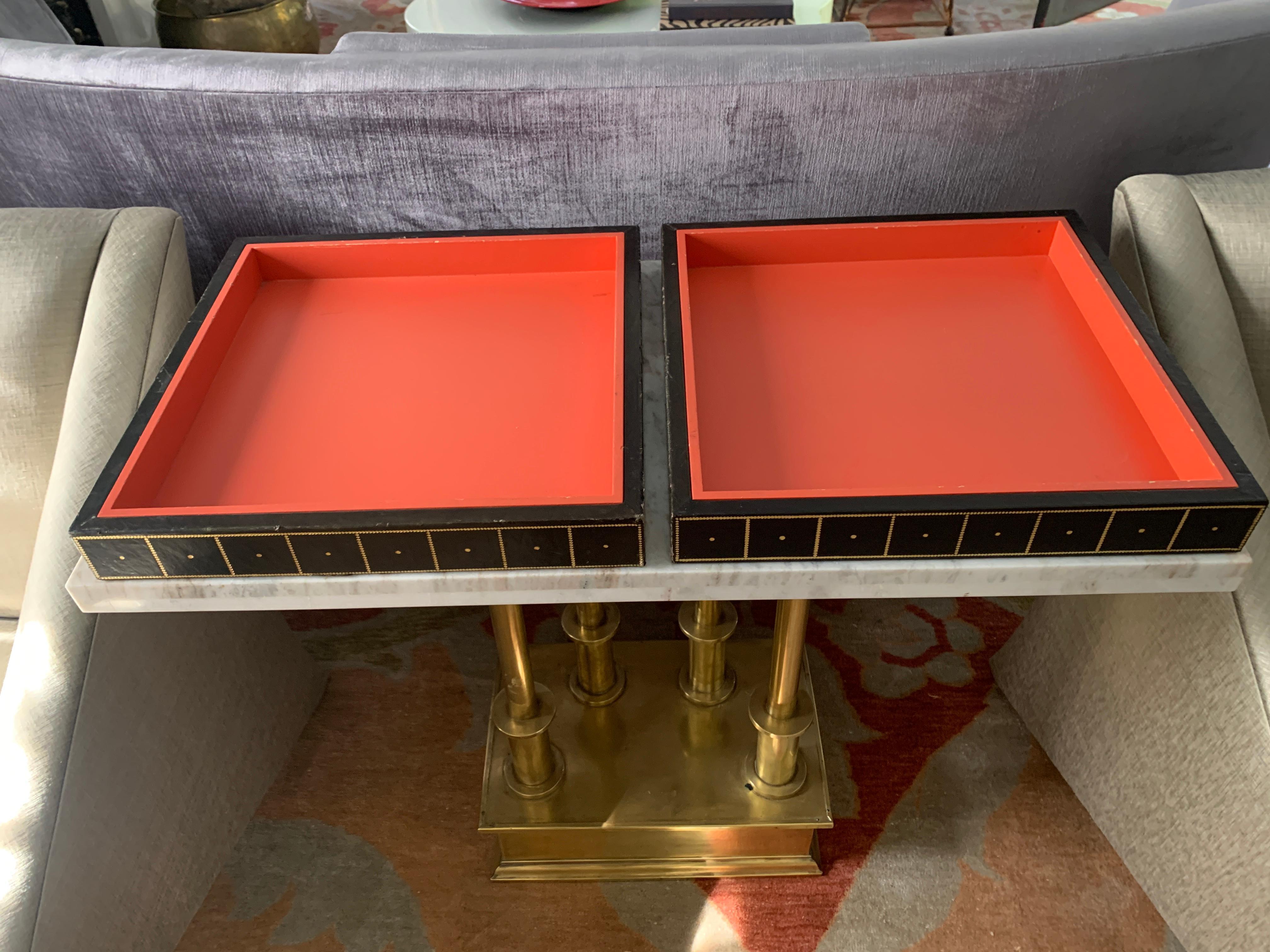 Two gold embossed leather and wood trays in orange and black -

The trays have a wonderful embossing of gold -the perfect complement to the midcentury home or game room... While the trays are functional to carry items from the bar or kitchen, they