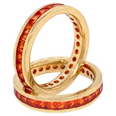 Two Gold Eternity Stacker Bands with Channel-Set Square Cut Orange Sapphires