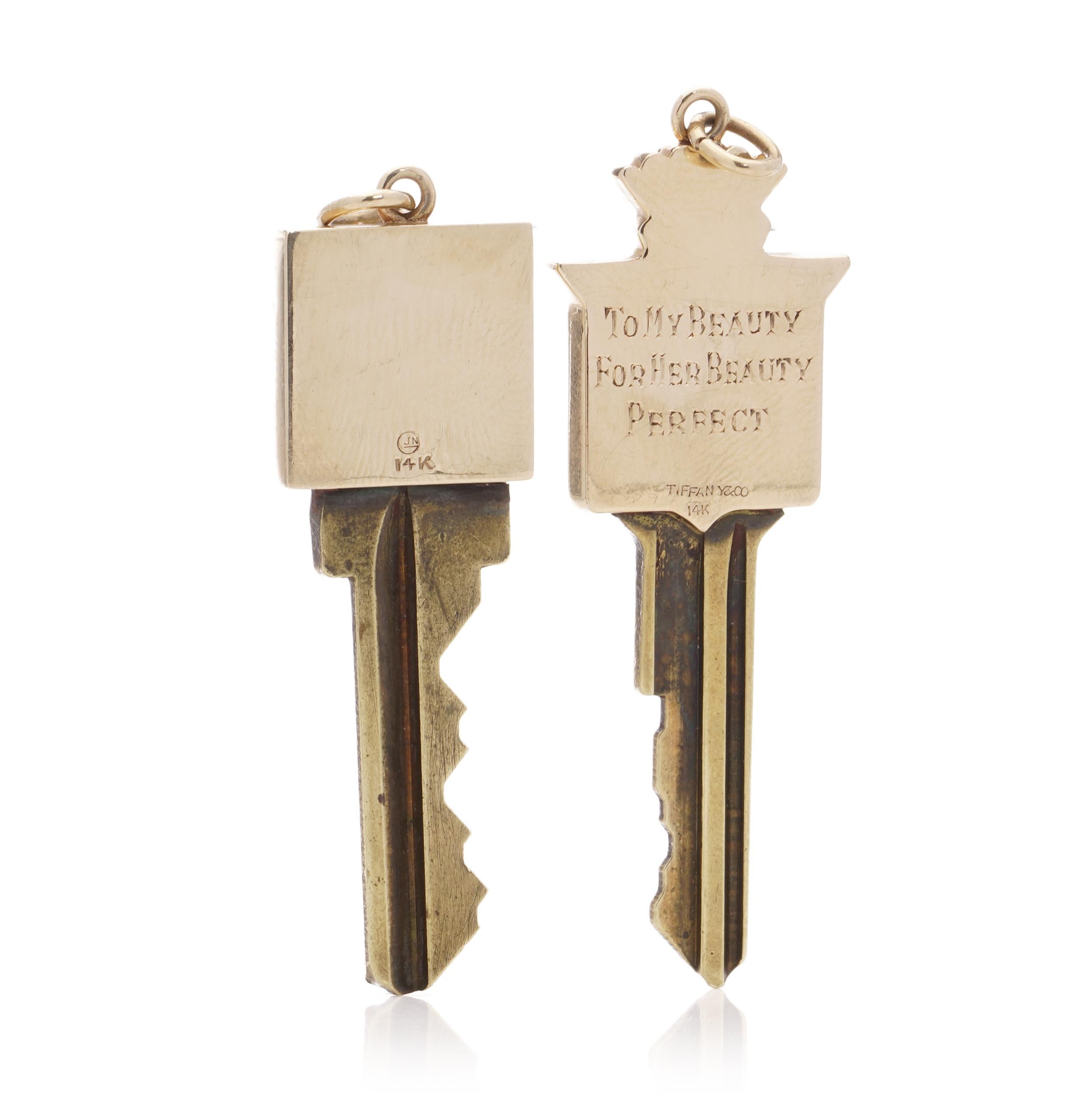 Two gold mounted keys, one with Cadillac logo design finial, engraved verso 'to my beauty, for her beauty, perfect', stamped Tiffany & Co 14k; the other of plain form, stamped GJN 14k, both with metal blades (2)

Property from the estate of the late