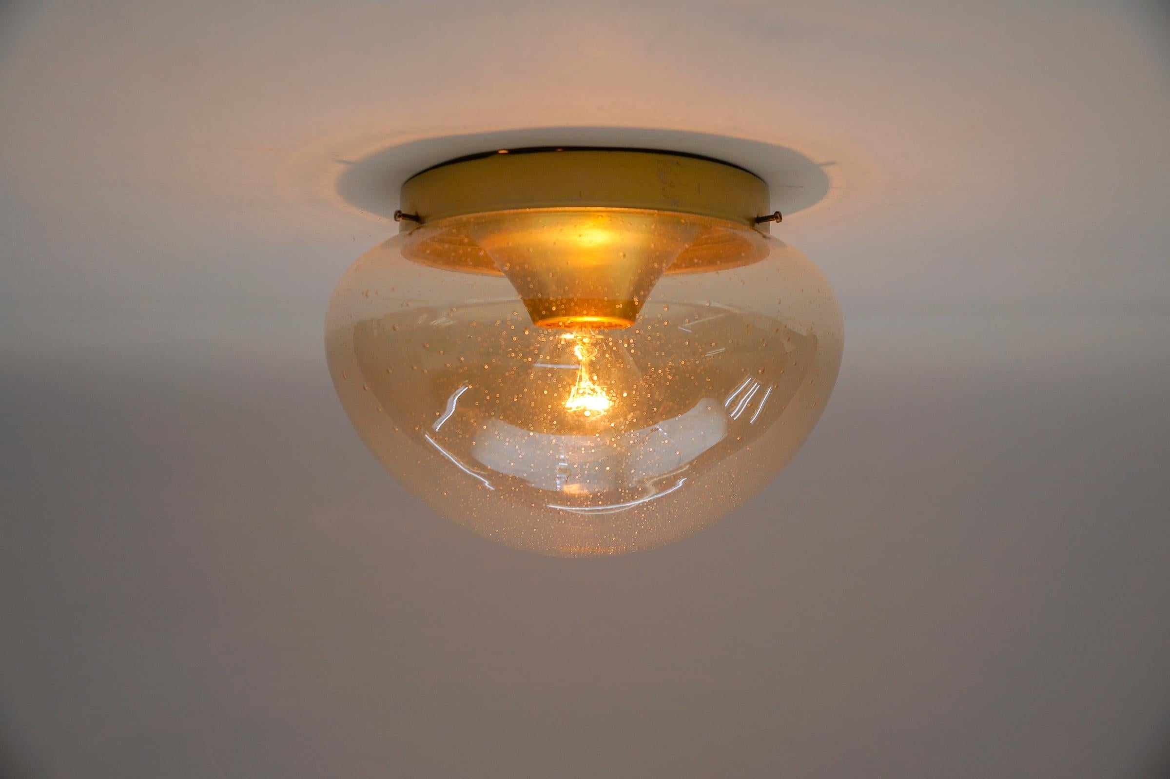 Two Gold Mushroom Shaped Glass Lamp, Germany, 1960s

Dimensions
Height: 7.08 in. (18 cm)
Diameter: 10.23 in. (26 cm)

The fixture need 1 x E27 standard bulb with 60W max.

Light bulbs are not included.
It is possible to install this fixture in all