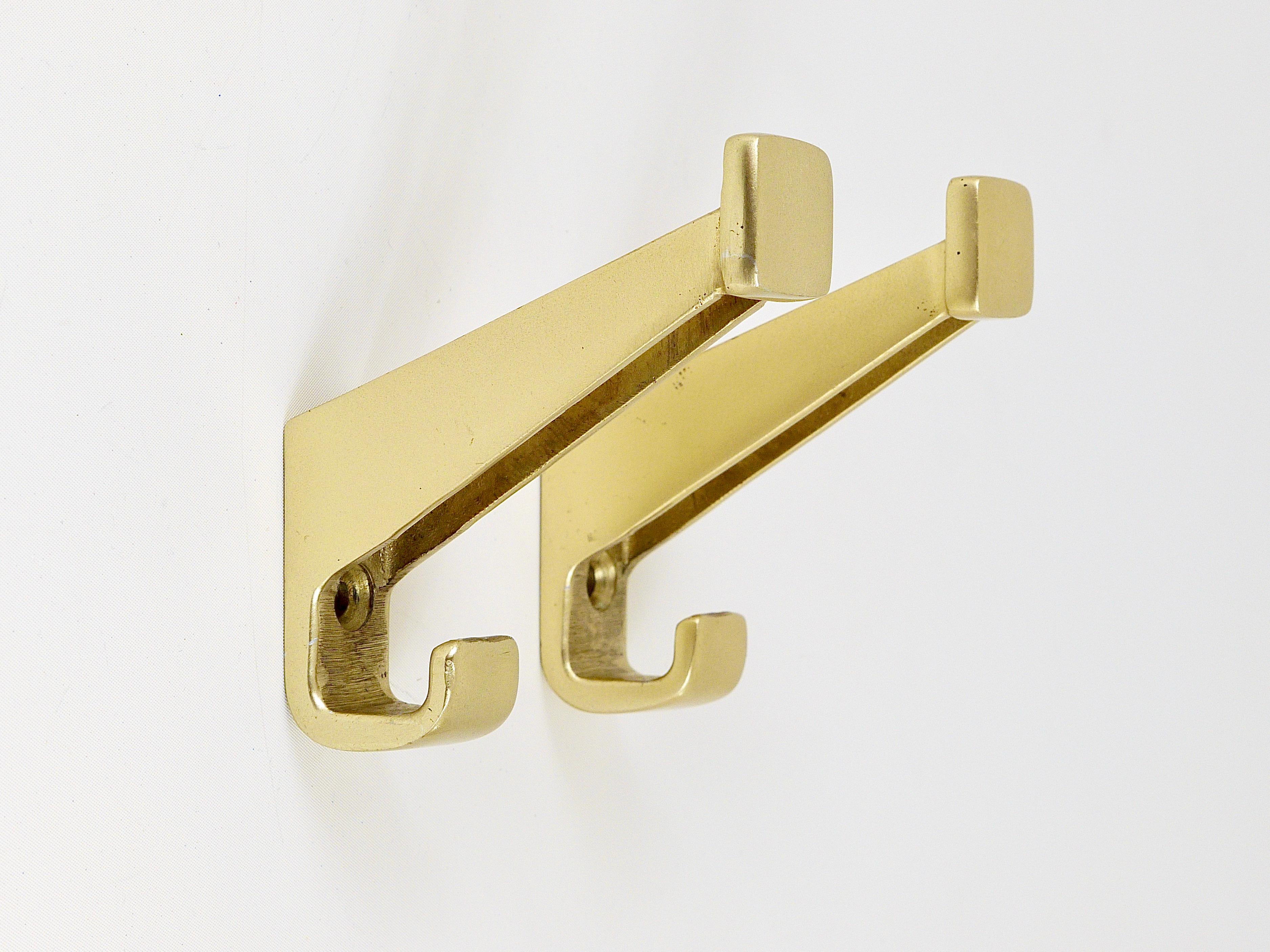 Two beautiful coat wall hooks from the 1930s, designed by Josef Hoffmann and Oswald Haerdtl for the Austrian Federal Railways. Made of golden anodized aluminum, in very good original condition with marginal wear.
