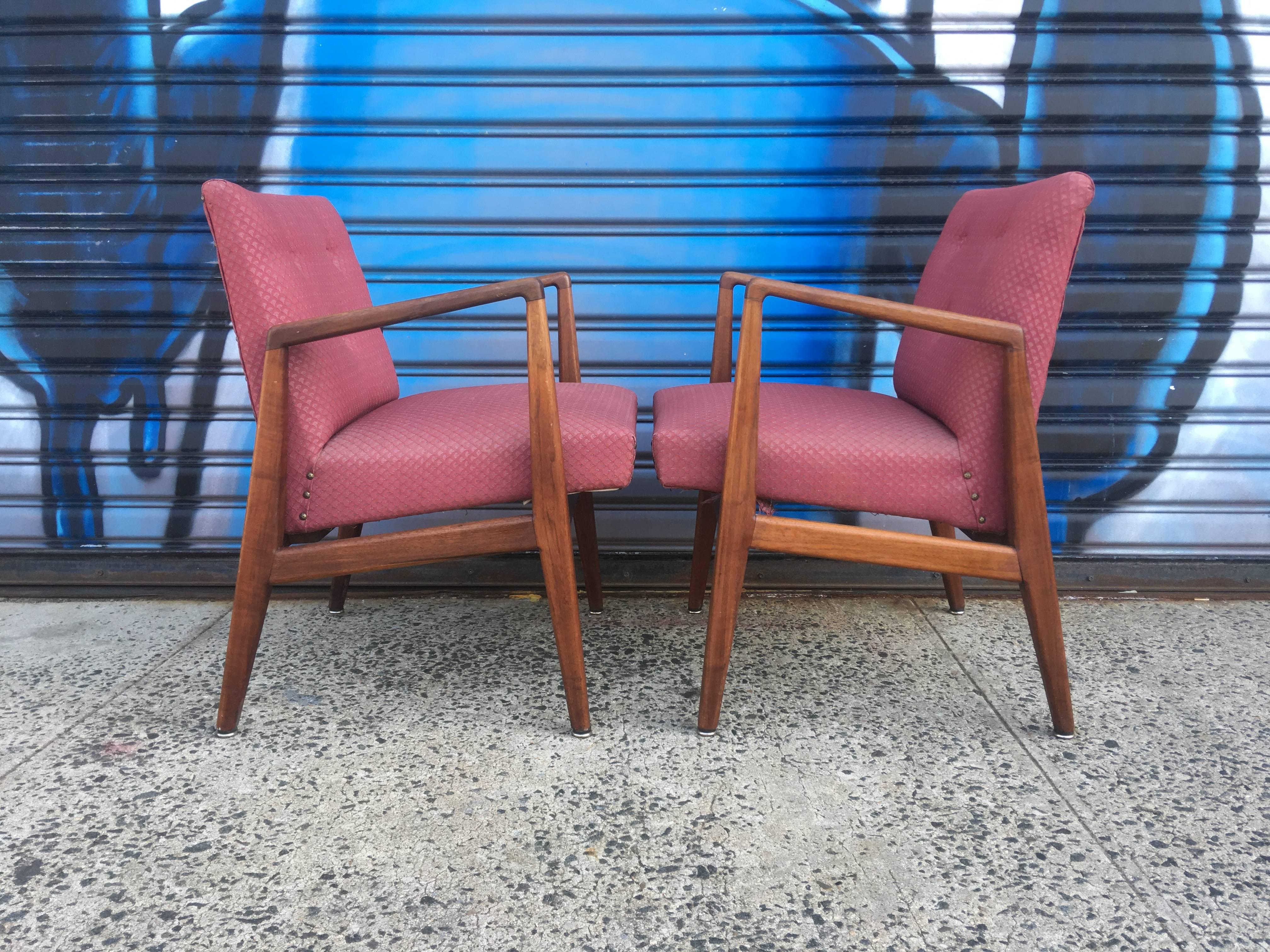 Two Jens Risom sculptural walnut armchairs. Textile in good condition. Wonderful wood color and grain. Structurally sturdy and easy to use.