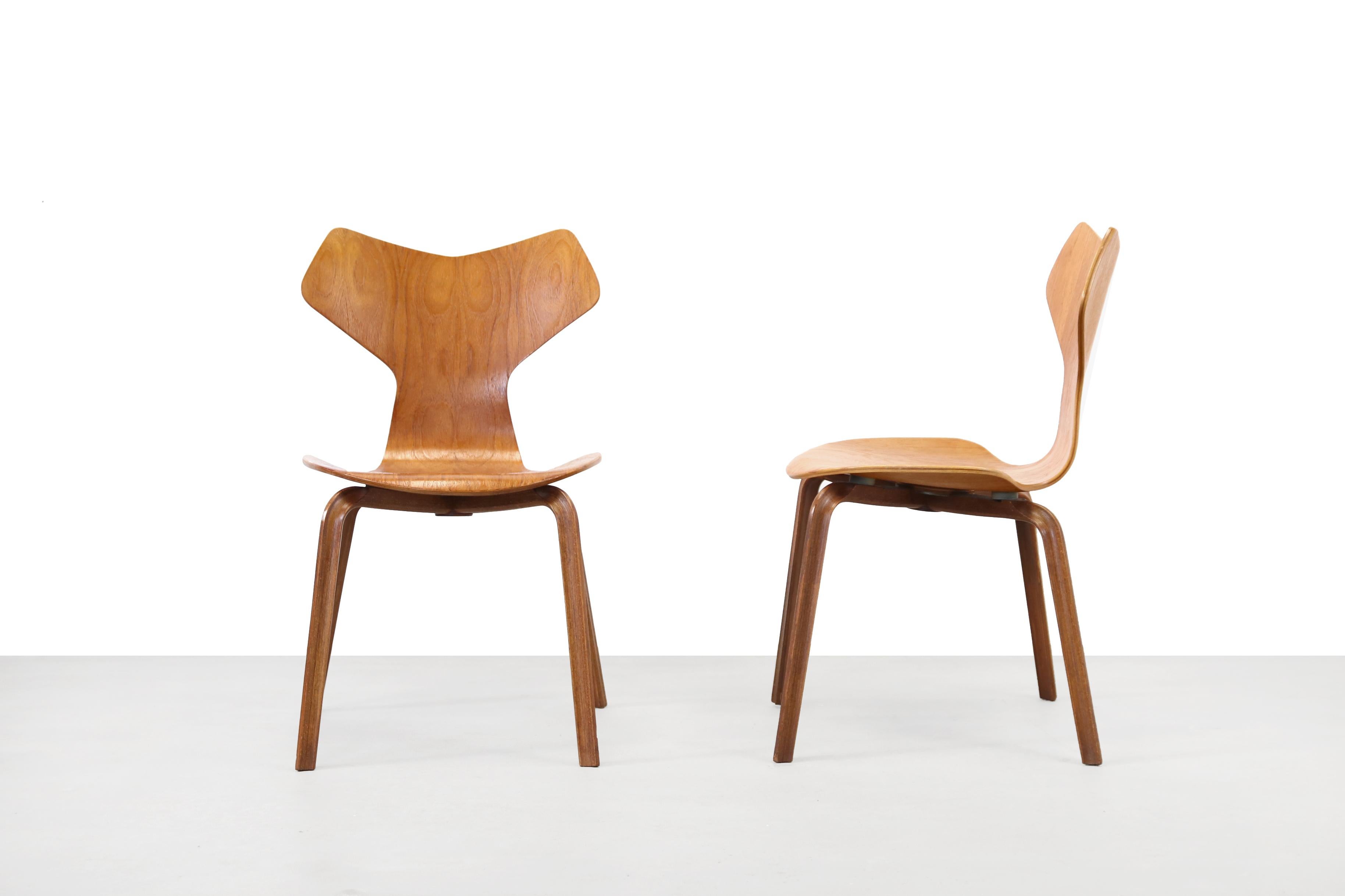 Two vintage teak Grand Prix chairs by Arne Jacobsen. These chairs were designed as 