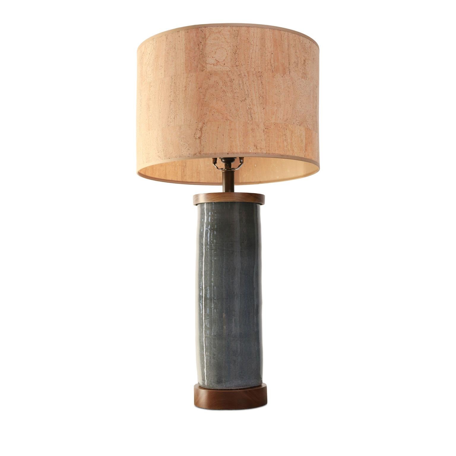 Two dark gray cylinder-shape table lamps, custom made from hand-thrown ceramic cylinders finished with walnut bases and tops. Newly wired for use within the USA using all UL listed parts. Includes complementary drum-shape cork shades. Table lamps