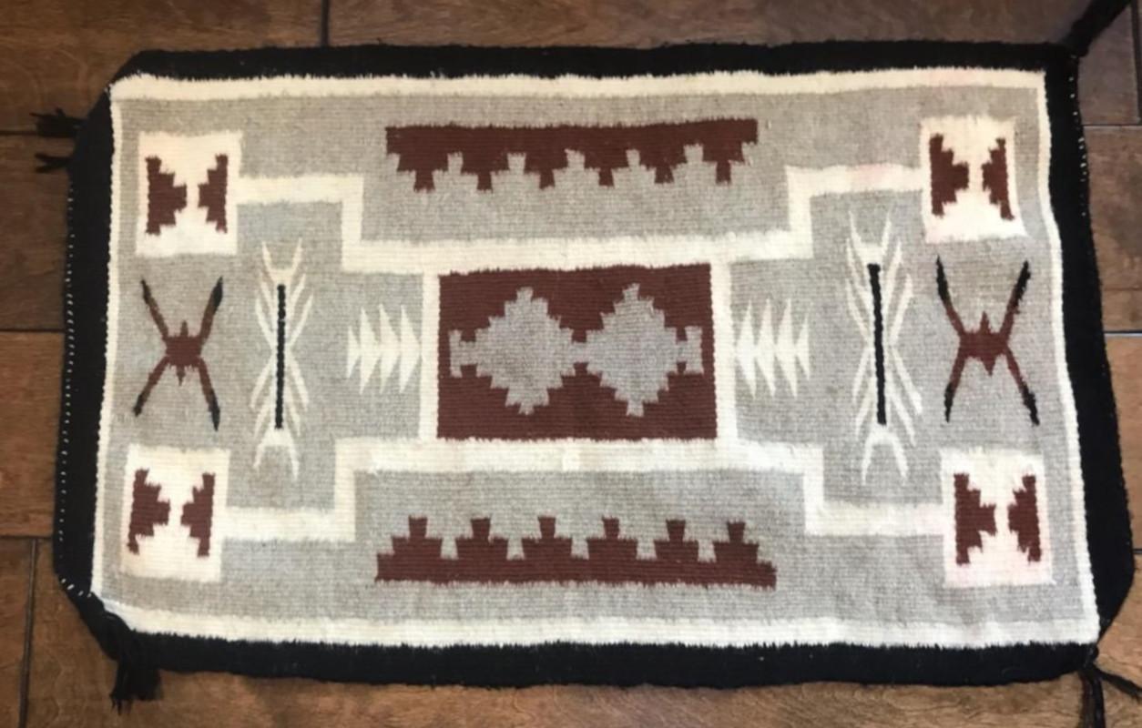 This fine two grey hills weaving is in fine condition and has the original corner ties. This small weaving could make a great pillow.