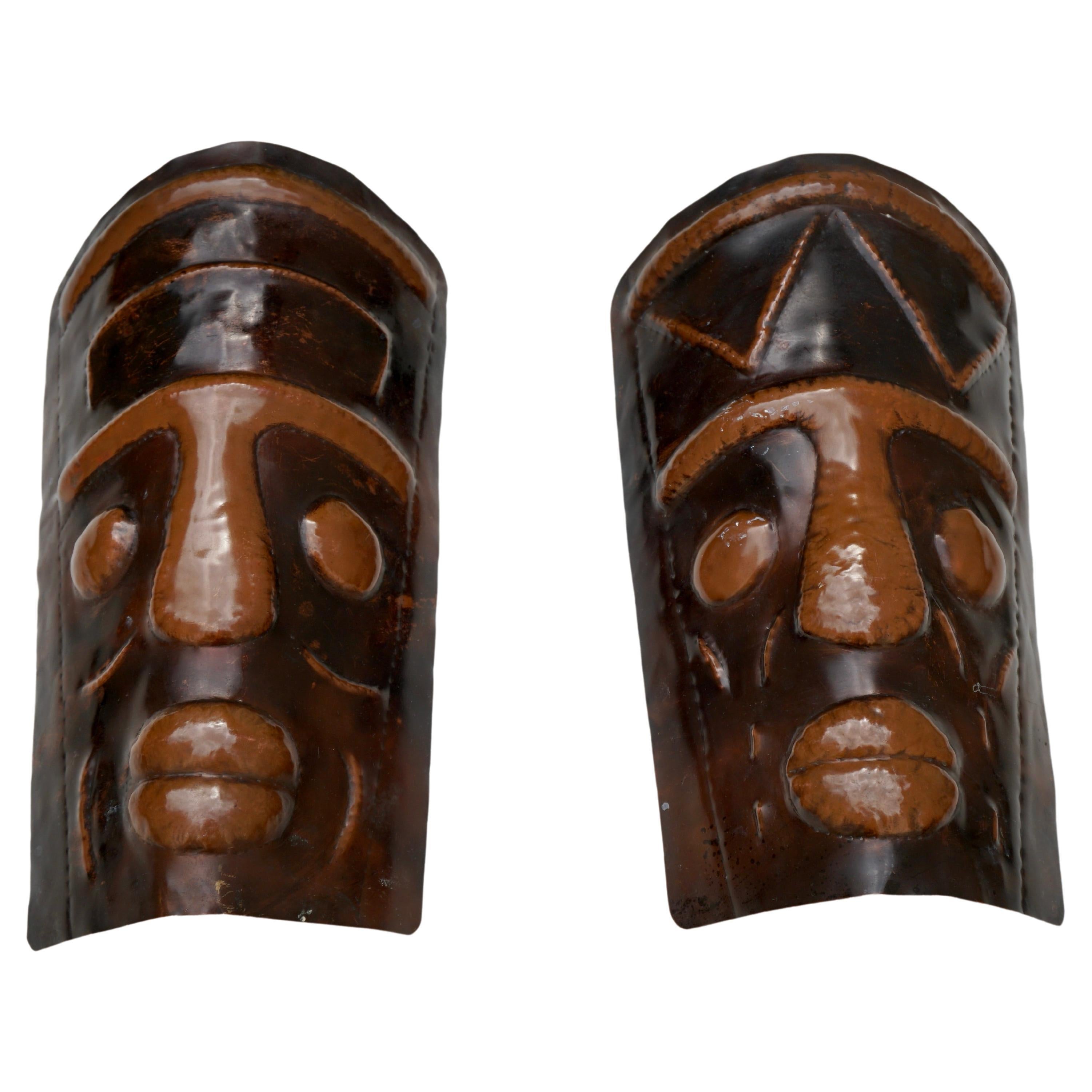Two Hammered Copper Sconces in the Shape of African Masks For Sale