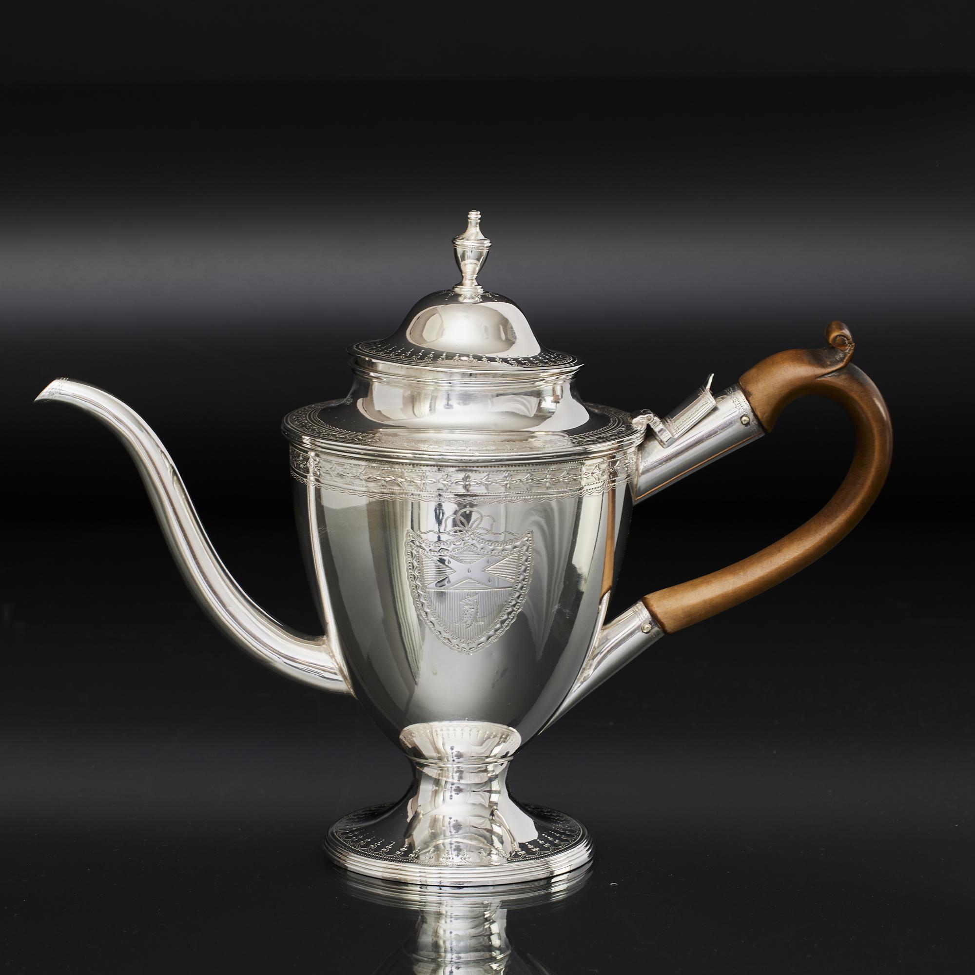A fine antique silver argyle, or argyll; a lidded gravy jug that features a hot water jacket that is filled with boiling water thus keeping the gravy or sauce hot. The water is poured through a lidded opening in the handle mount and fills the space