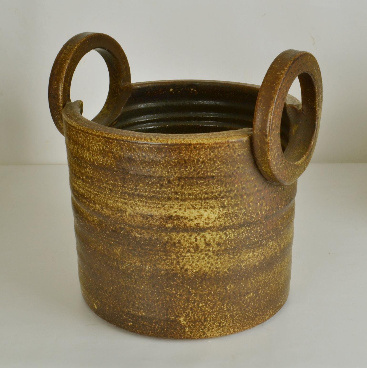 Large hand turned 1960's studio ceramic plant pot with over sized handles is created on the turning wheel by highly technical skilled Dutch ceramist Piet Knepper for Mobach. The glaze in browns and ocher is inspired by in nature and highly