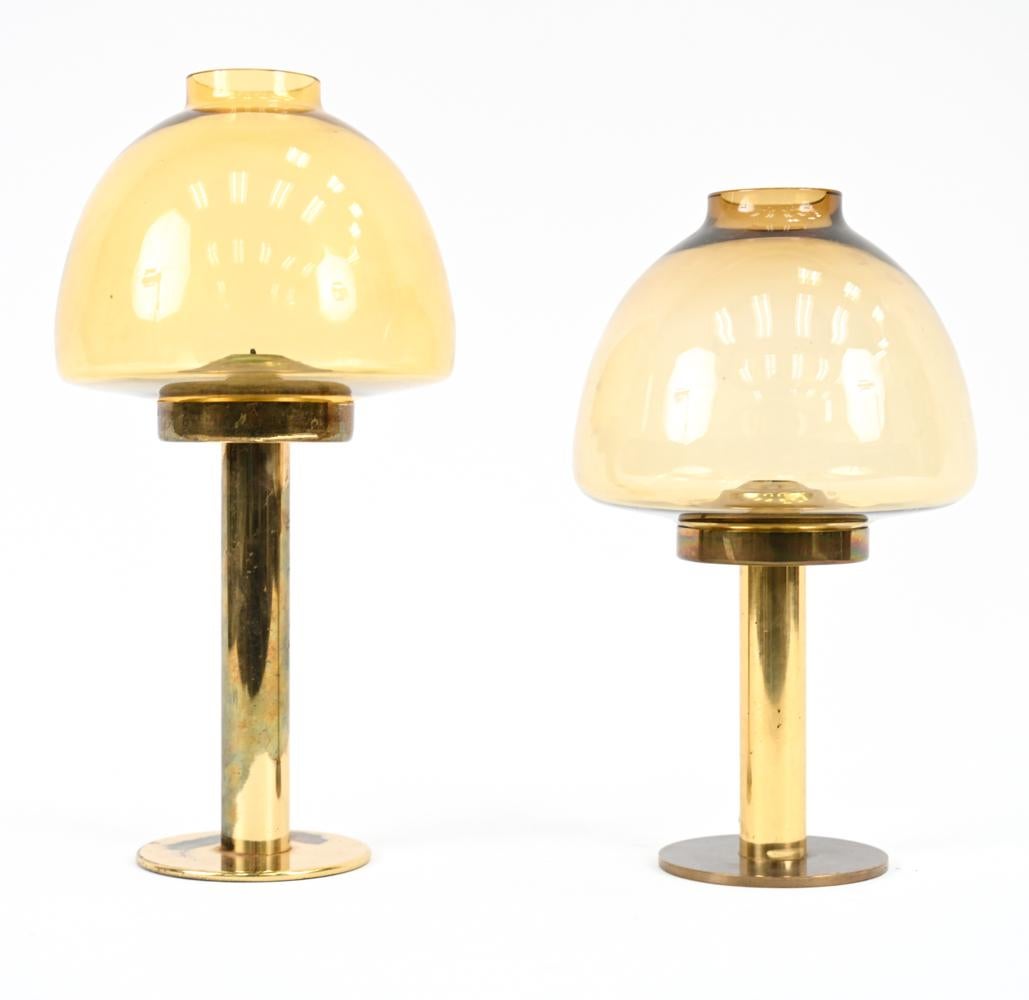 Two Scandinavian modern candle-stick form oil lamps with brass bases blown amber glass mushroom-form hurricane shades. Larger marked underneath: Hans Agne Jakobsson, AB Markaryd.