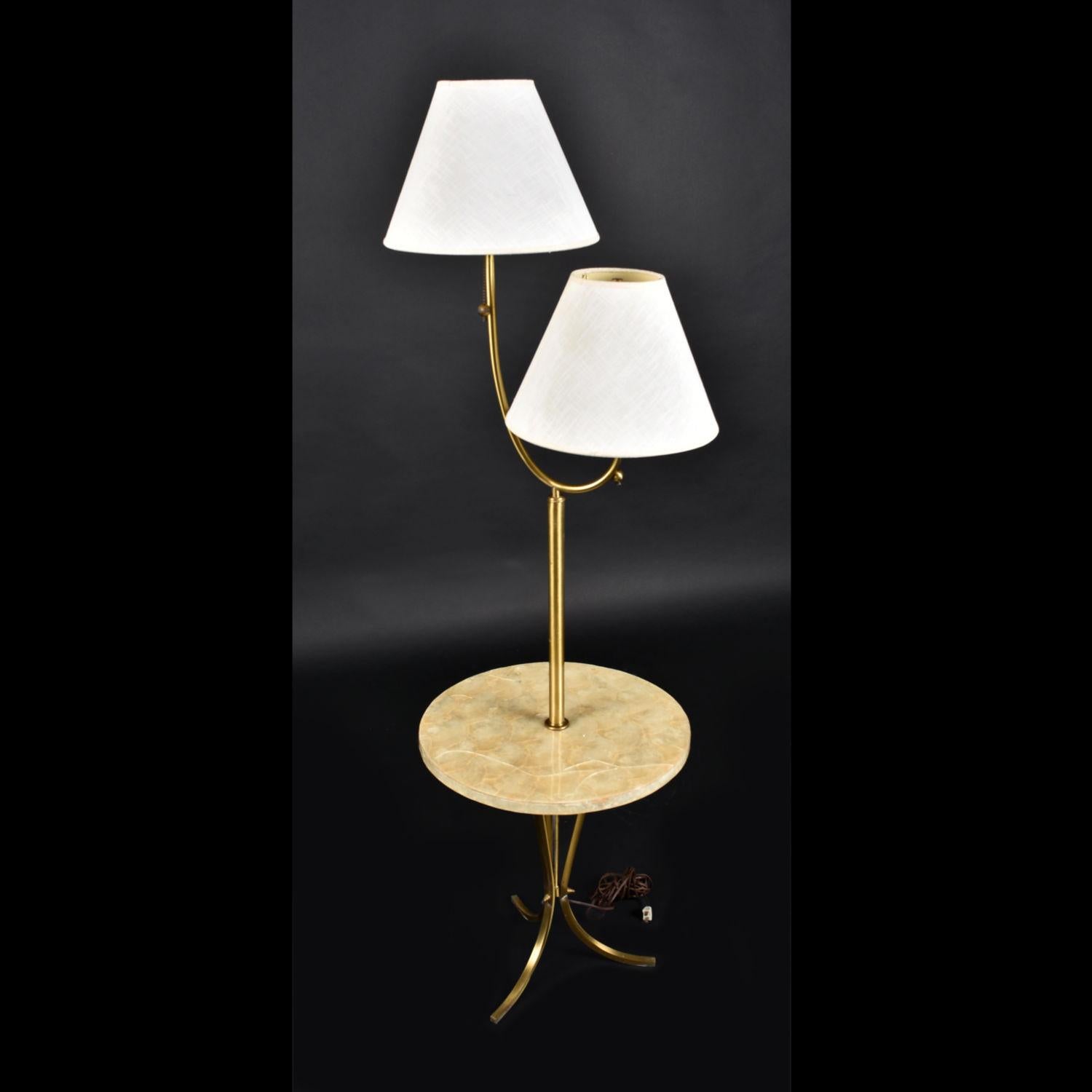 Everything about this Mid-Century Modern two-head floor lamp screams luxury. Each bit of the lamp was thoughtfully designed, right down to the nuts and bolts. The vintage floor lamp features two heads with 12
