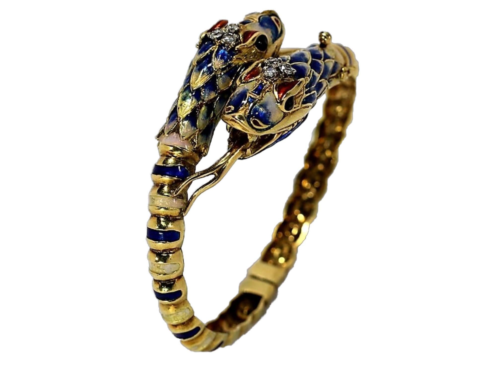 Crafted in 18k yellow gold and multi-color enamel, this exotic
and striking bangle features two snake heads, each measuring
1 1/2 inch long by 1/2 inch wide,  topped with three diamonds.
The six diamonds have a  .25CT total approximate weight.
The