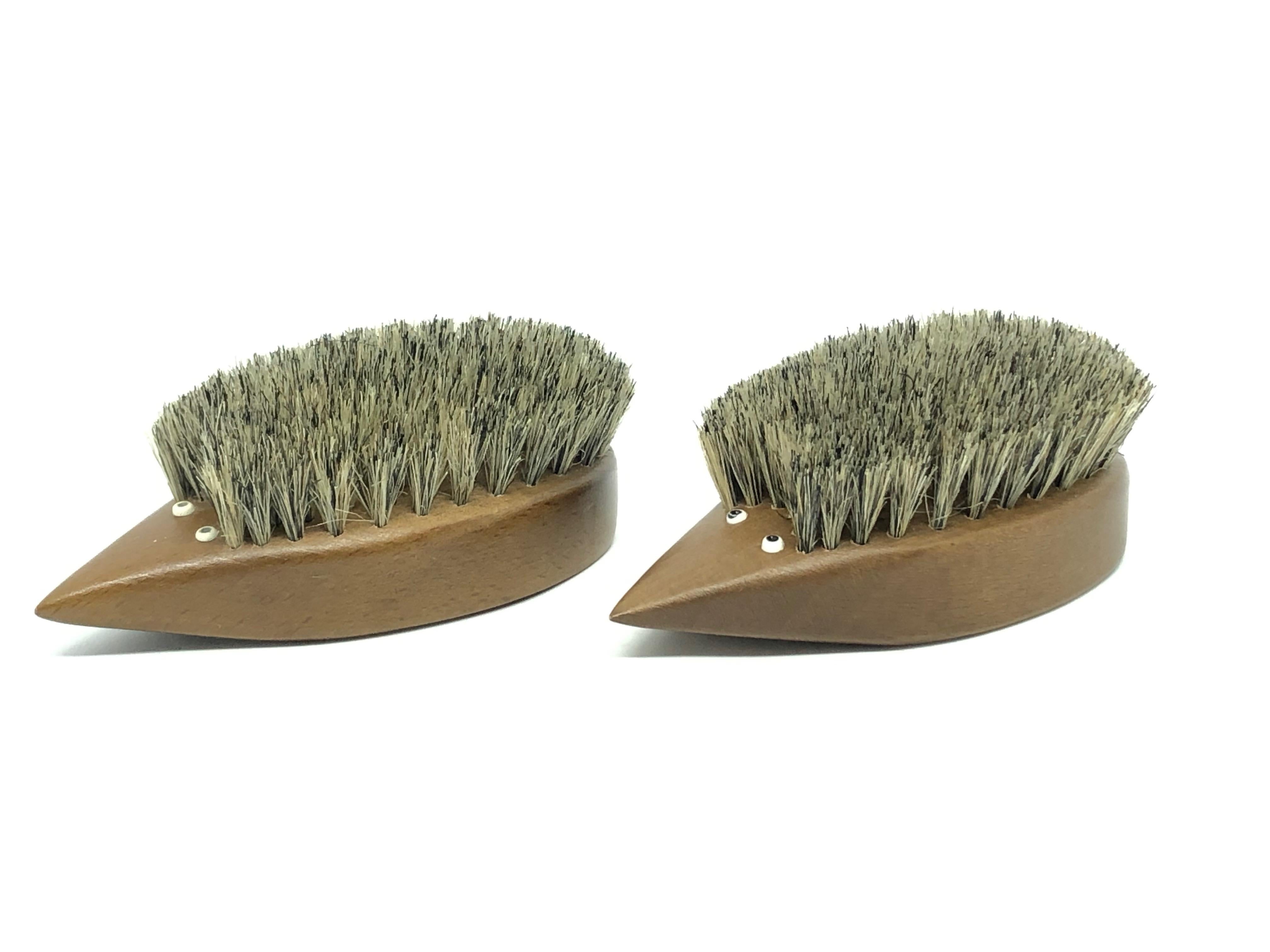 Classic early 1960s Danish design teak wood brush set of two in the form of a hedgehog. Nice addition to your room or just for your collection of Design items. Made of teak wood and hair. They have glass eyes. Found at an estate sale in Vienna,