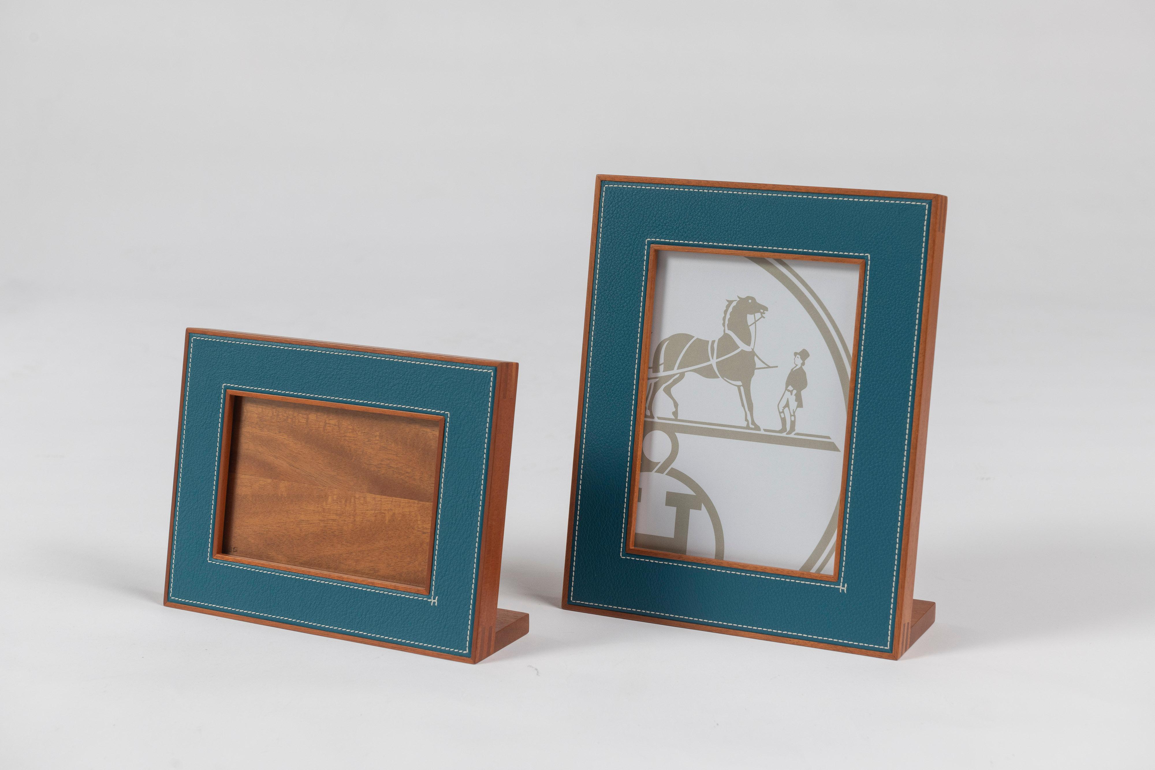 Two timeless Hermes Pleiade signature blue regate leather picture frames, smaller one is 8.5
