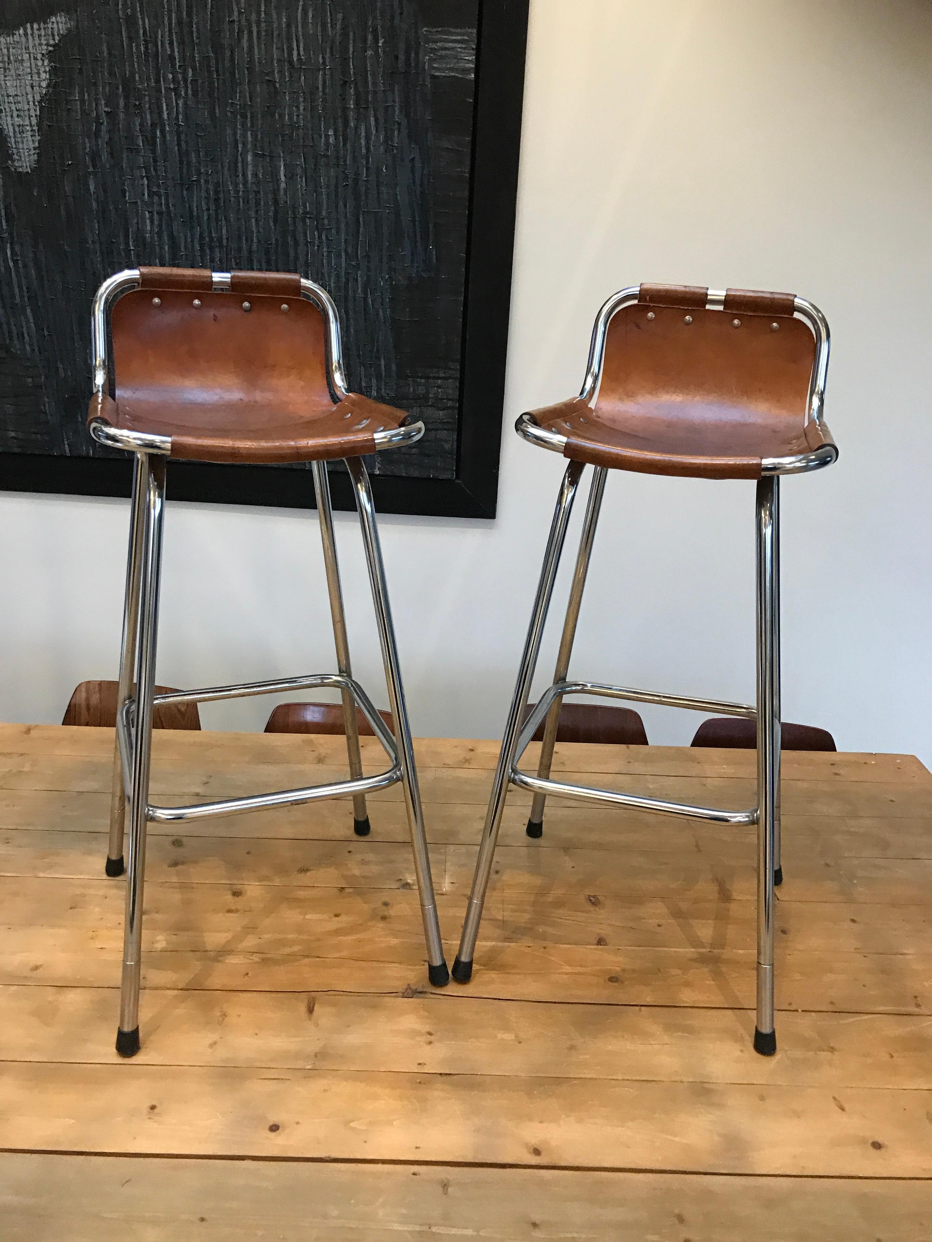 Stunning set of two stools, designer Charlotte Perriand used these in the Ski Resort Les Arcs, circa 1960. These stools were commissioned to be made by Cassina, one of the best Italian furniture maker’s, very nice chrome tubular frame with thick