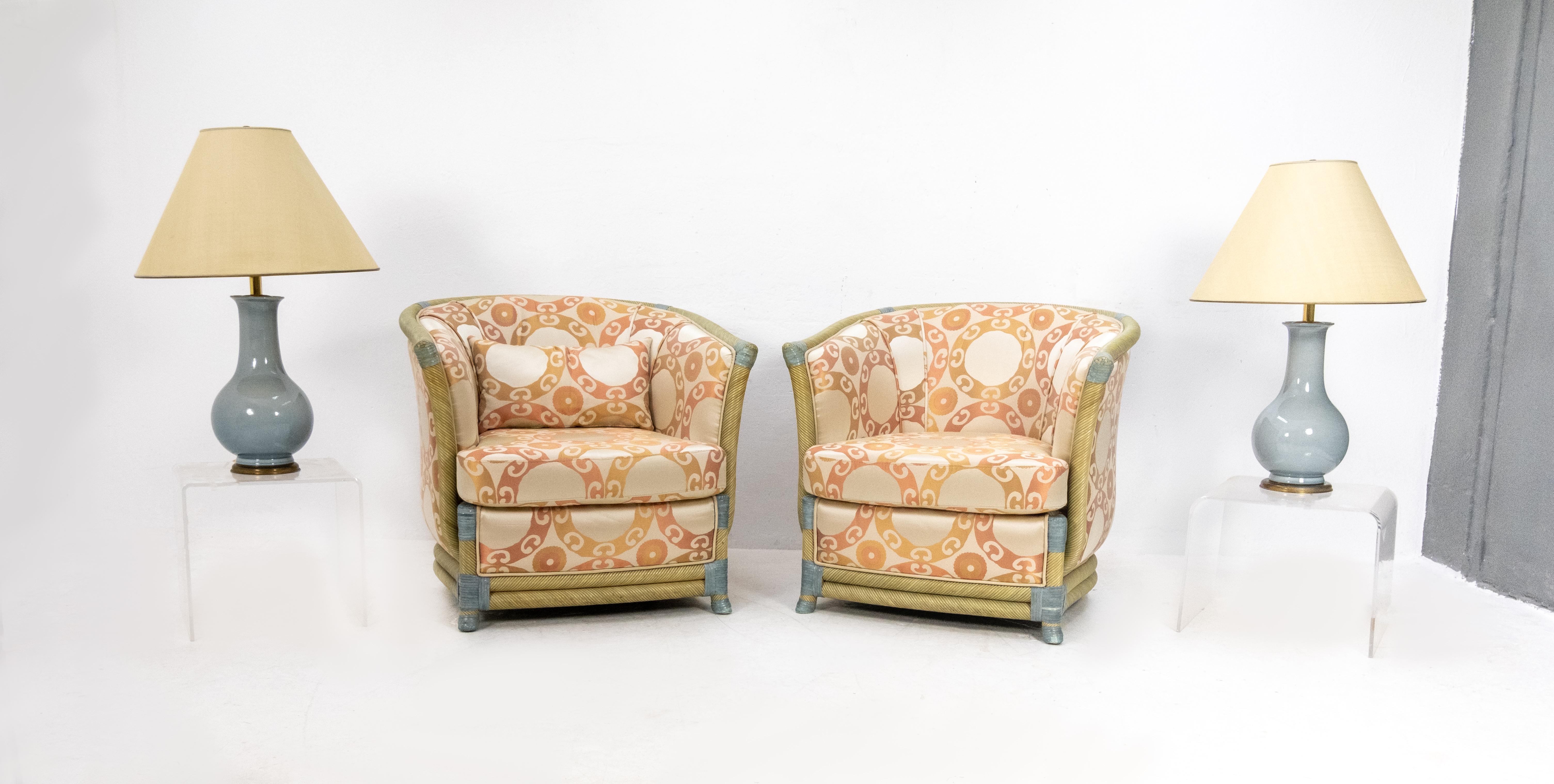 Two unusual Hollywood Regency wicker club fauteuils. Outstanding quality made. Curved and colored wicker frame.
Comes with a silk upholstery geometric pattern, France, 1980s. Very good condition.
  