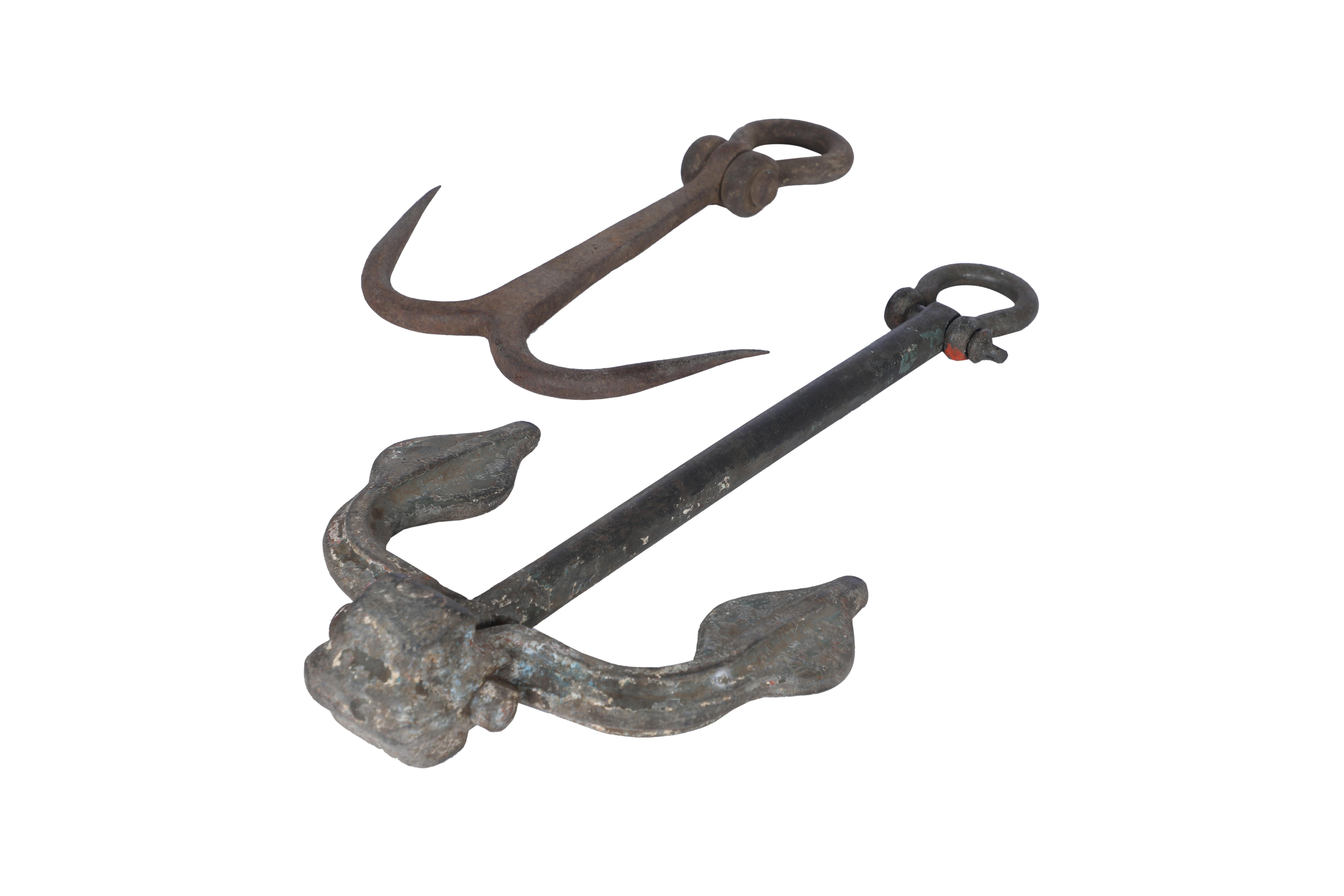 Two old iron anchors with great sculptural appeal.  They could actually still be used as anchors for a small boat, but would look great as sculptures on the wall.  Circa 1950's.  Price is for both.  The larger one is 24 x 12 x 2.5