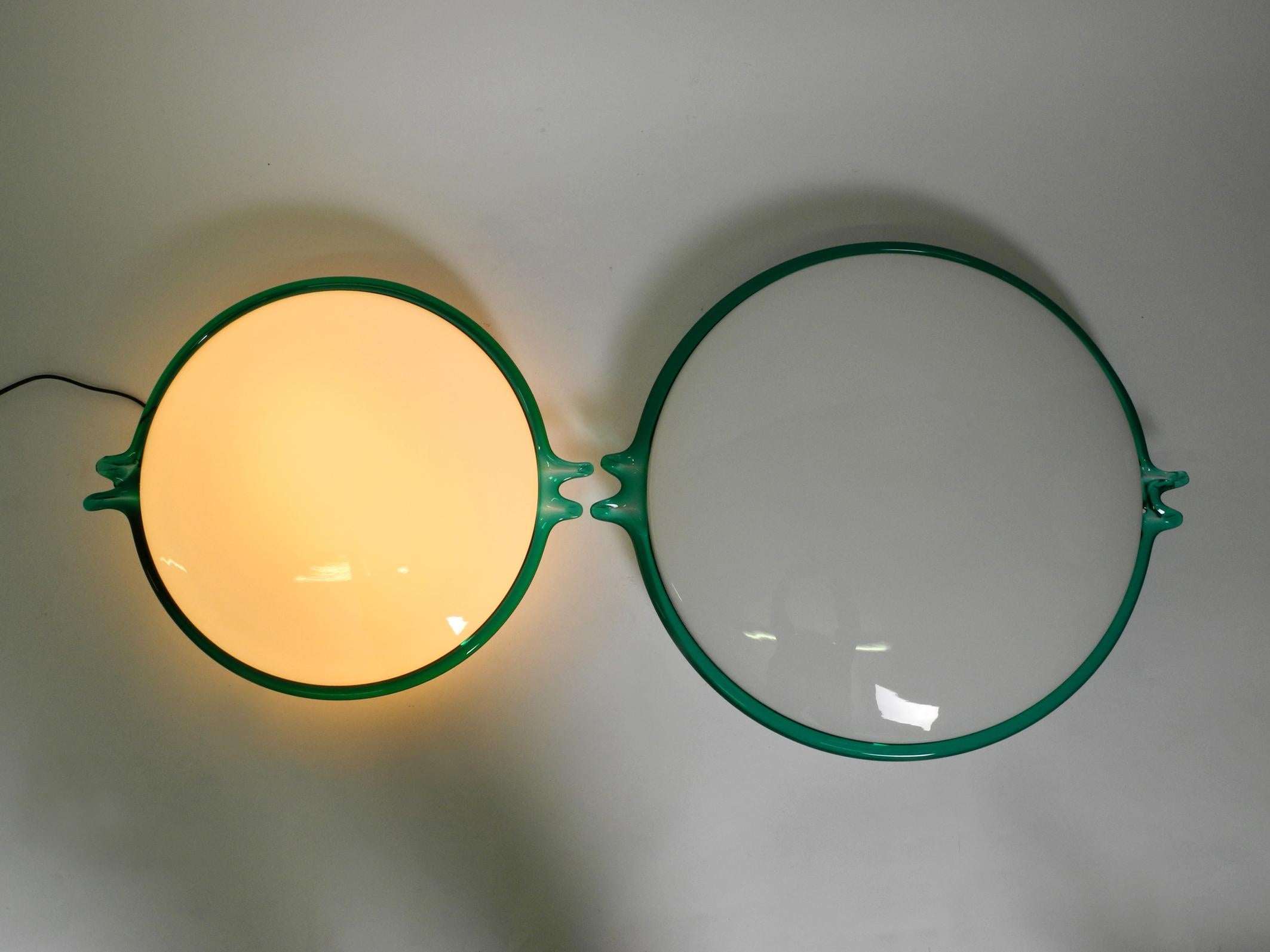 Two beautiful rare 1960s Italian ceiling or wall lamps handmade from Murano glass.
Great minimalist mid century design. Inside made of white Murano glass, 
the edge is made of slightly transparent green glass.
There is a small crack from below on