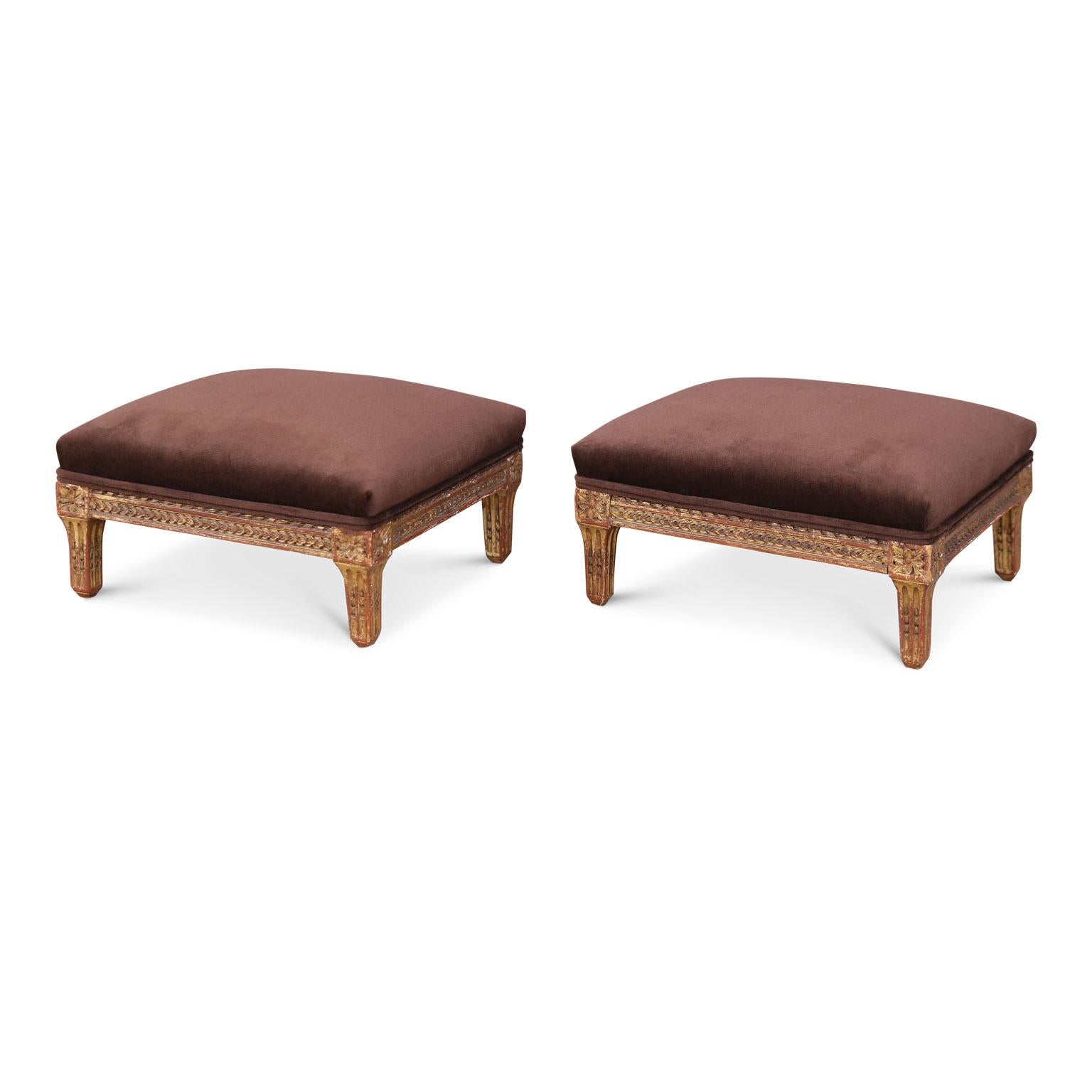 Two Italian giltwood footstools, neoclassical in style, hand-carved in the early 19th century and newly reupholstered. Sold as a pair.