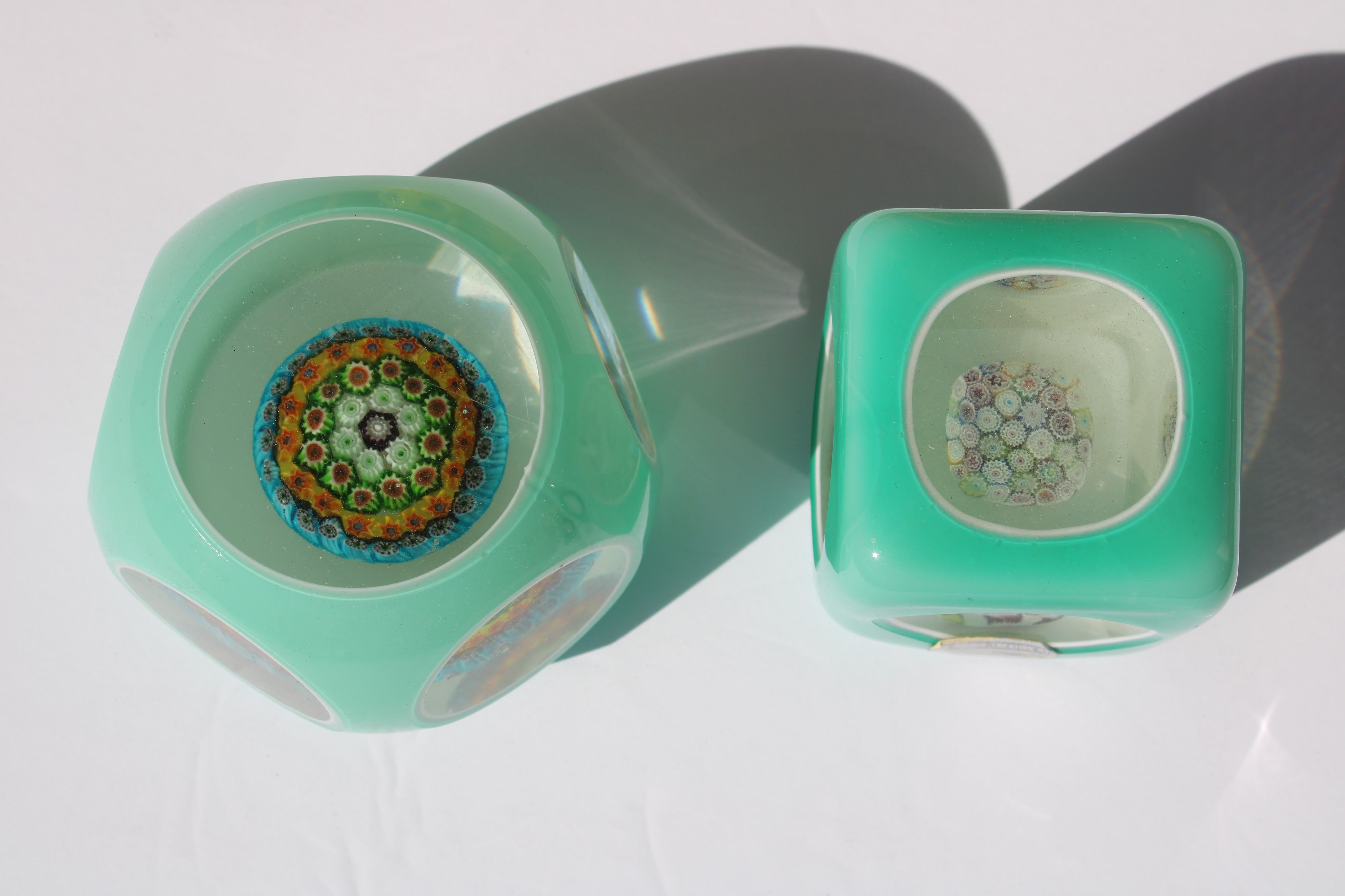 Two Italian Murano millefiori aqua cased glass paperweights.  The square paperweight is 2.25