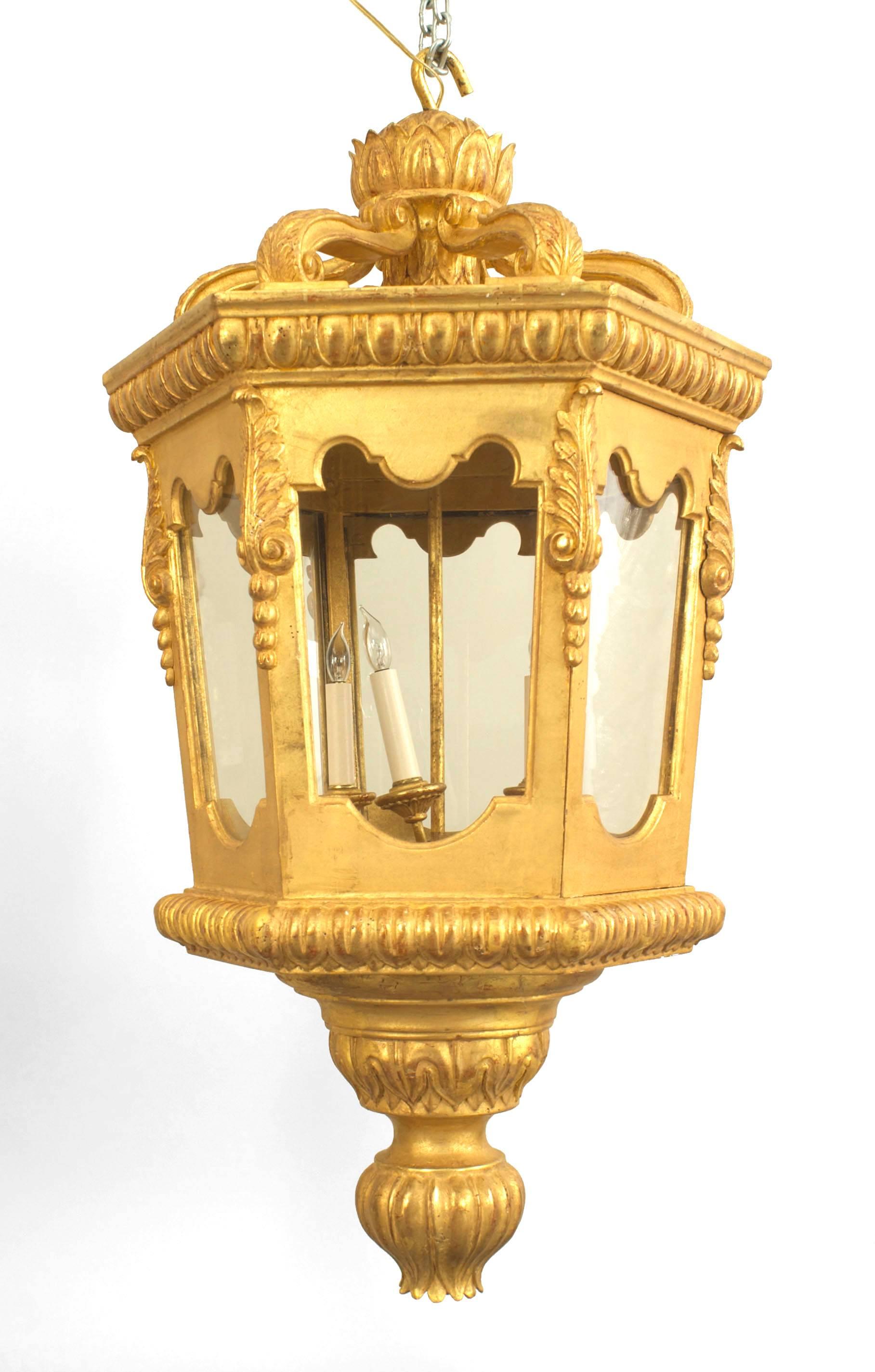 Two Italian Rococo-style (20th Century) gilt carved octagonal lanterns with shaped glass panels and a large fluted finial bottom (PRICED EACH)
