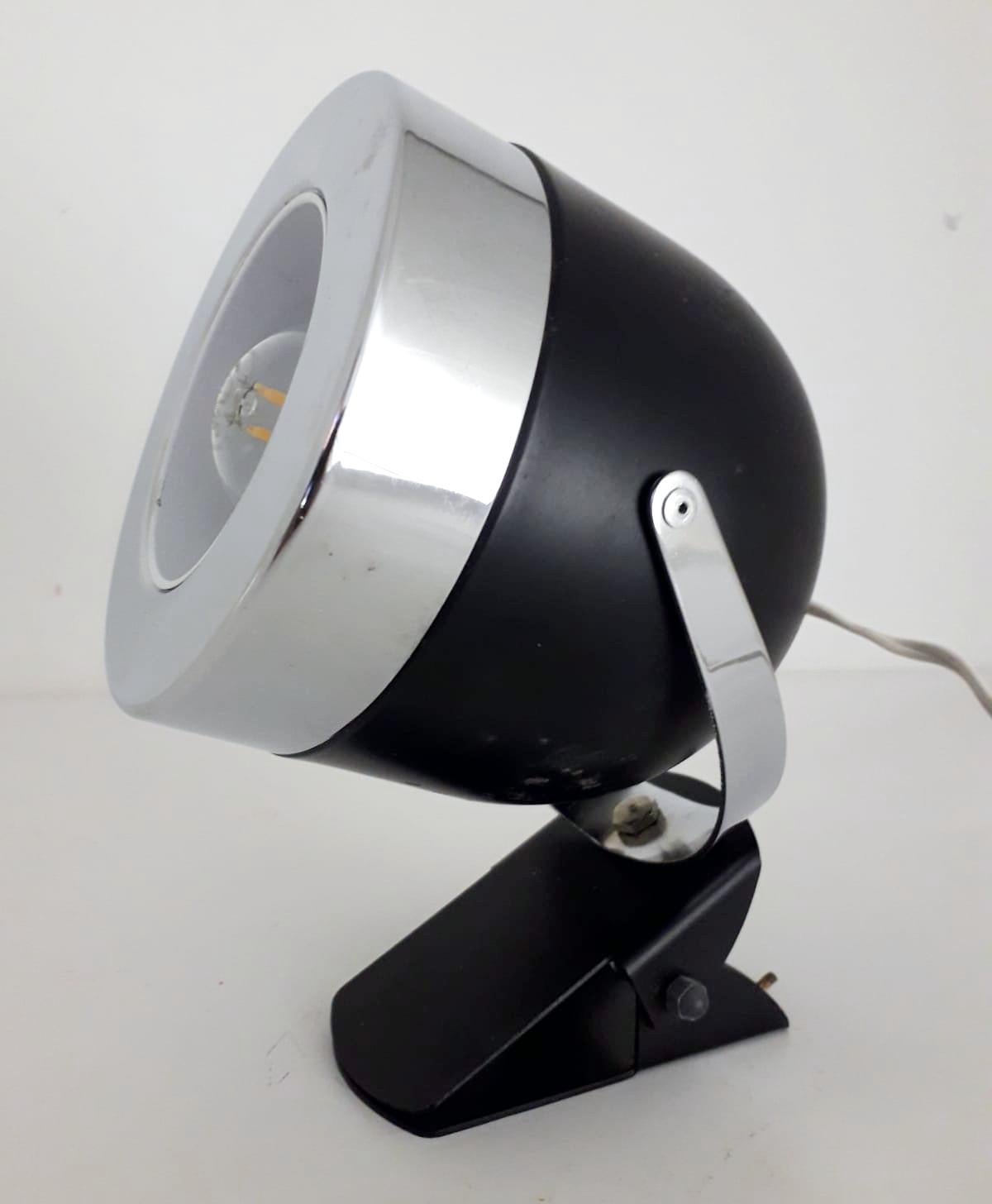 Vintage Italian adjustable spotlight with matte black enameled body and chrome hardware, mounted with simple clip base, can be used as wall light or table lamp / Made in Italy circa 1970s
1 light / E14 type / max 40W
Measures: Height 7 inches /
