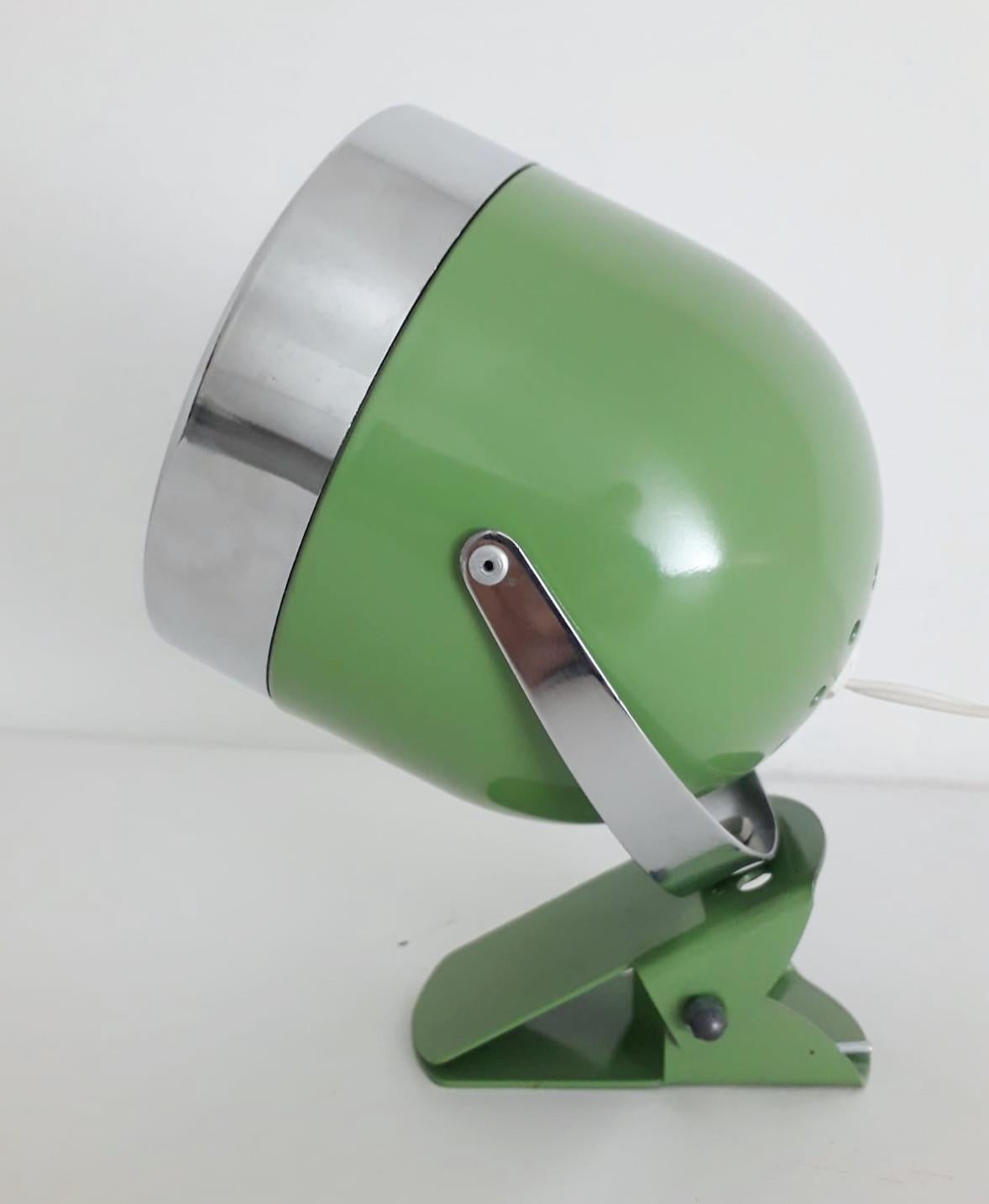 Vintage Italian adjustable spotlight with glossy green enameled body and chrome hardware, mounted with simple clip base, can be used as wall light or table lamp / Made in Italy circa 1970s
1 light / E14 type / max 40W
Measures: Height 7 inches /