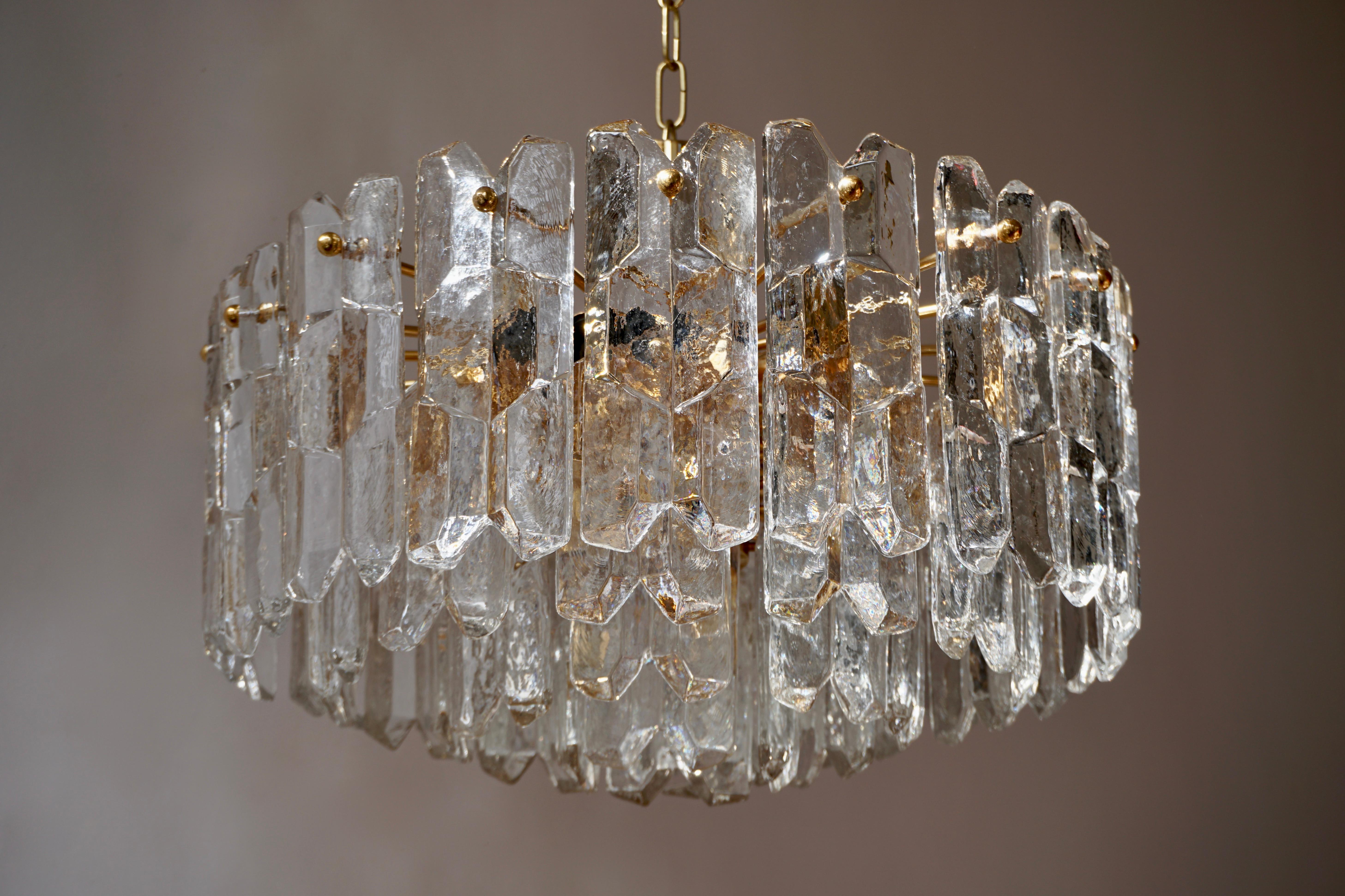 One very exquisit 24-carat gold-plated brass and clear brillant glass light fixture by J.T. Kalmar, Vienna, Austria, manufactured in midcentury, circa 1970 (late 1960s and early 1970s). 

The model name is 'Palazzo'. The lamps are marked with a