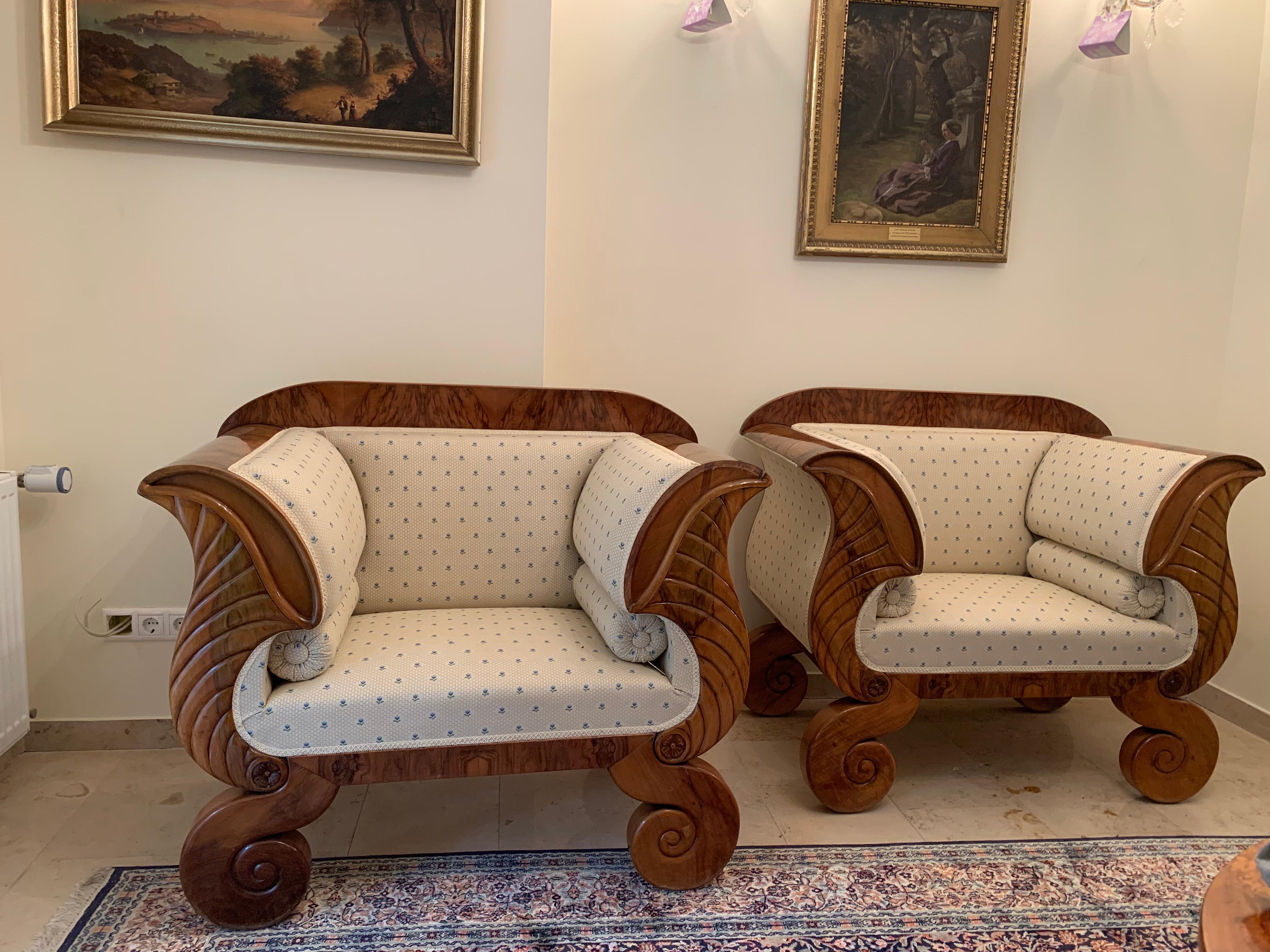 Two large Biedermeier armchairs circa 1850 in a typical cream material with blue flowers.
These two chairs are very comfortable chairs made from walnut.
The Biedermeier period refers to an era in Central Europe between 1815 and 1848, during which