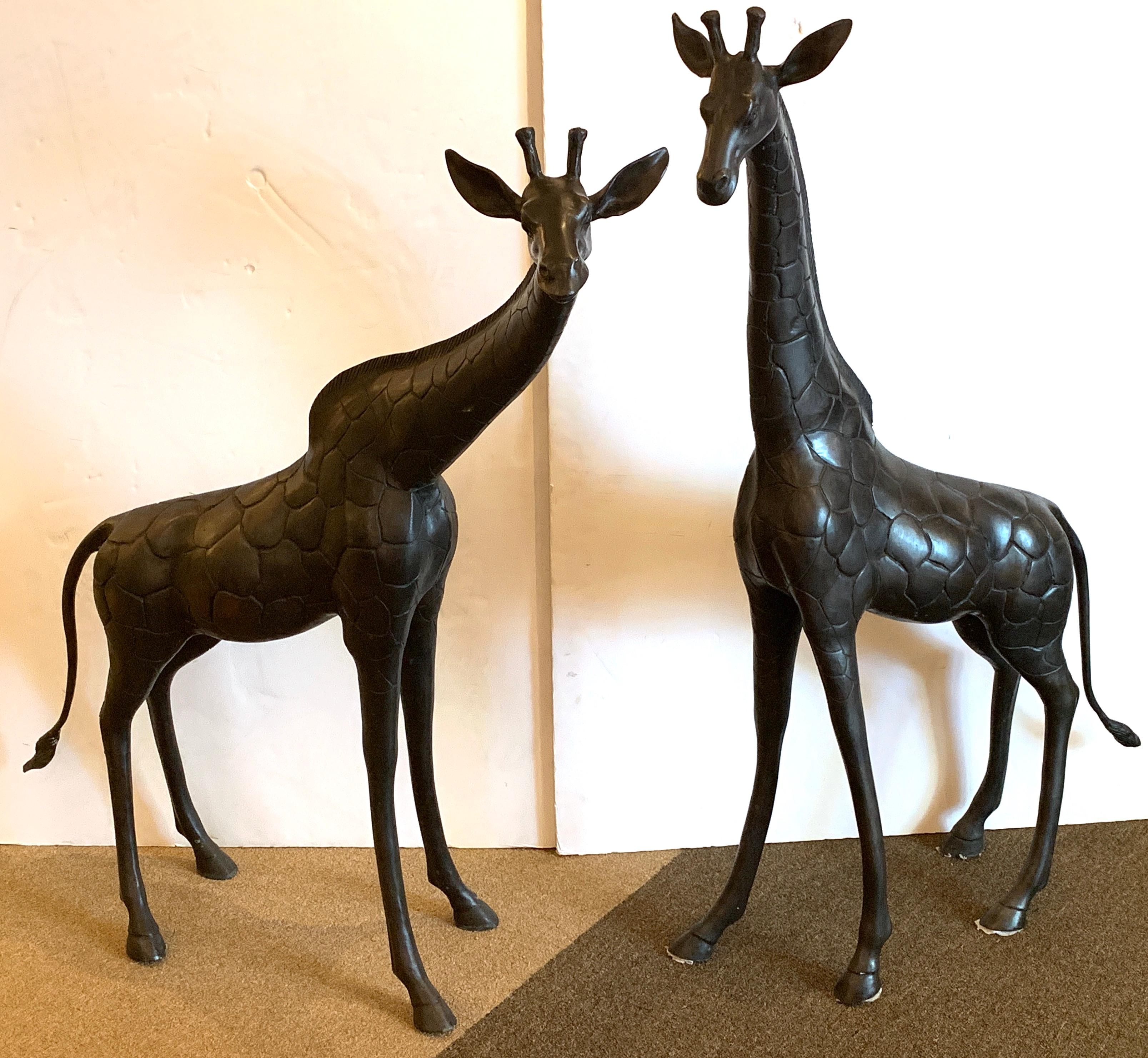 Two large bronze sculptures of giraffes, each one realistically cast and modeled, Unsigned
Measures: Larger giraffe 52