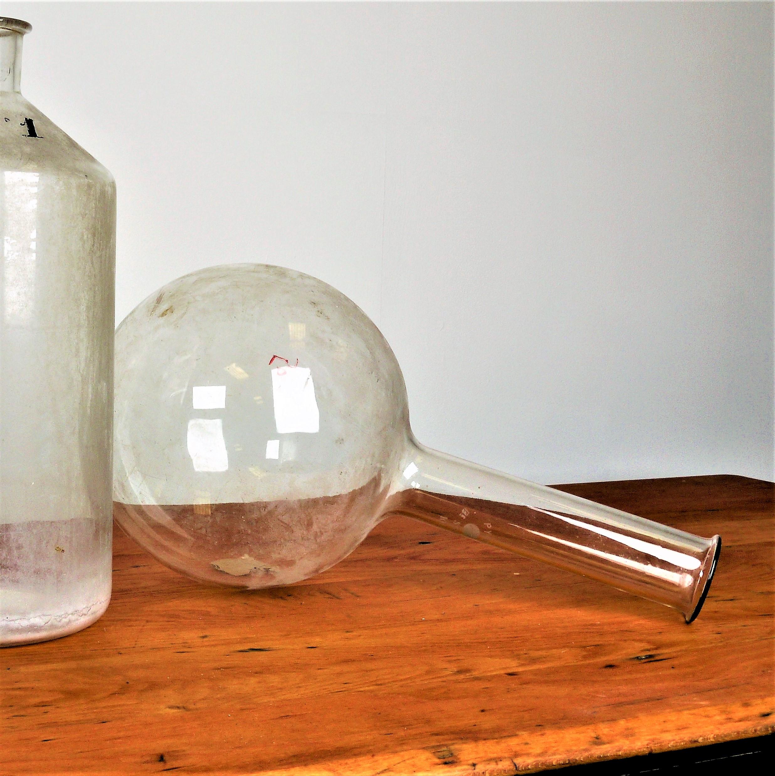 Two large decorative 1950s glass laboratory containers
Two large vintage decorative 1950s glass oversize laboratory containers. They can be cleaned but we prefer them as they are a little cloudy. Dimensions are for scale and are for the upright