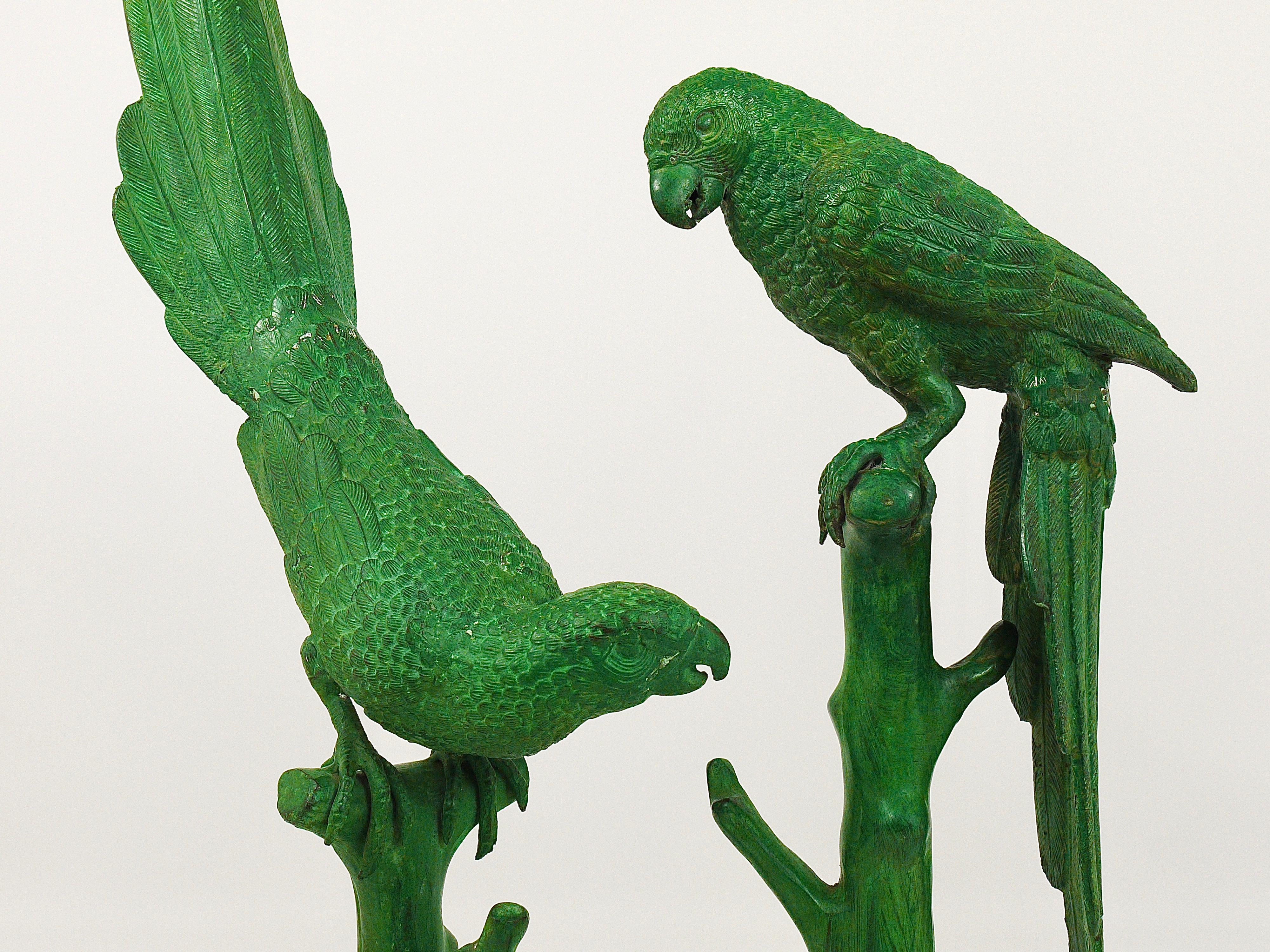 Two beautiful and large French bronze sculptures / figurines from the 1970s, displaying parrots sitting on a branch. Very impressive and decorative objects in good condition. Measures: Height 25 and 34 inches. Sold and prices per piece.
