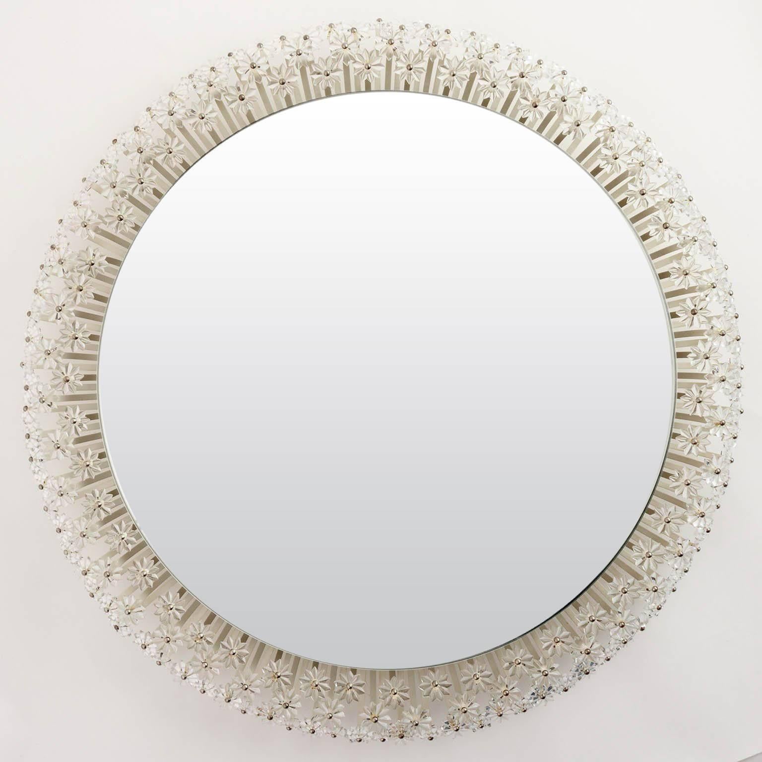 One of two large wall mirrors with illuminated background by Emil Stejnar for Rupert Nikoll, Vienna, Austria, manufactured in midcentury. A round mirror is surrounded by hundreds of glass flowers. This kind of mirror is available in different sizes