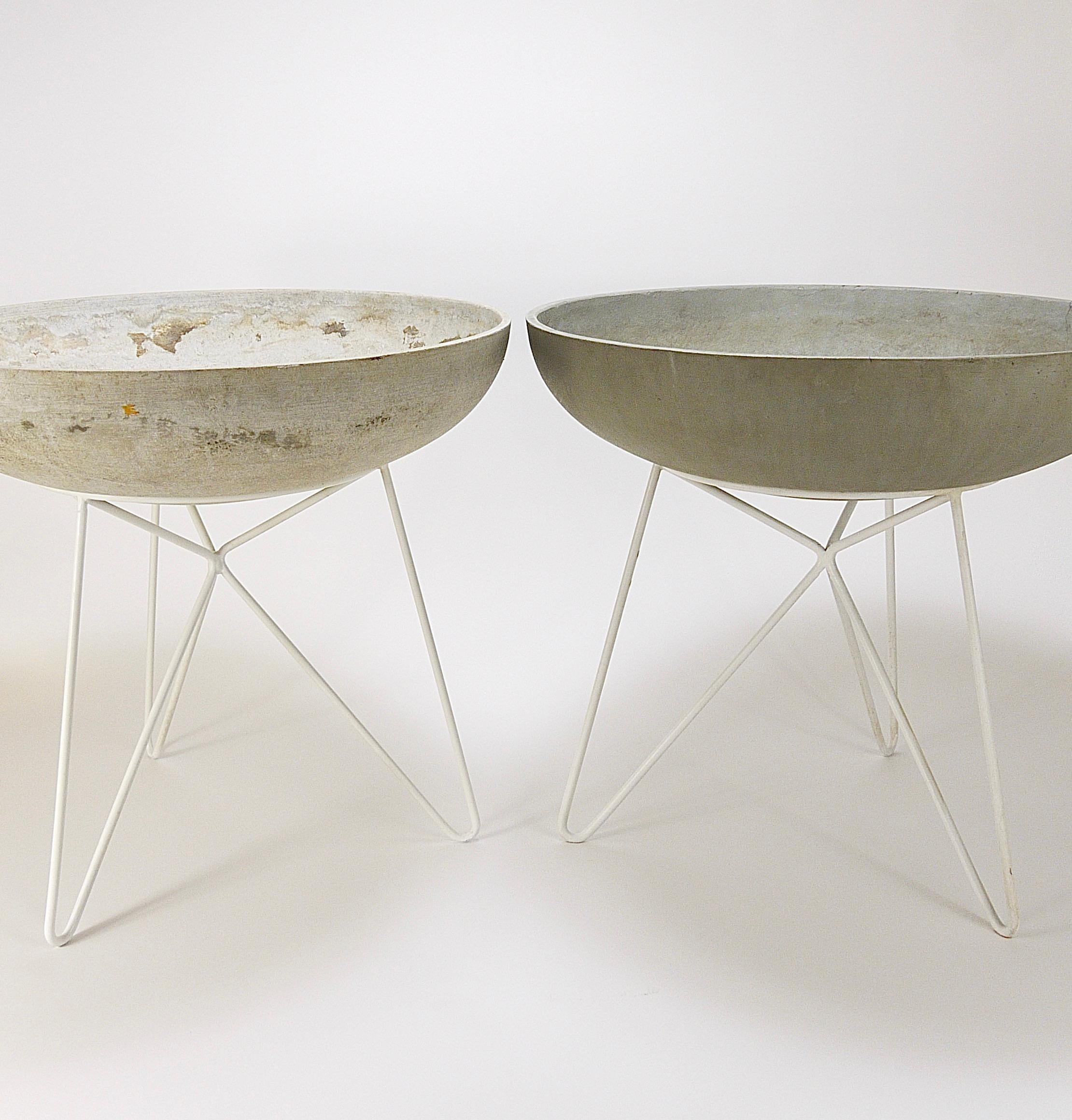Up to two beautiful round large  21 1/2 in. diameter Midcentury concrete bowl planters / fiber cement saucer flower pots with white painted iron tripod hairpin leg stands from the 1950s by Eternit of Switzerland. In good condition in original
