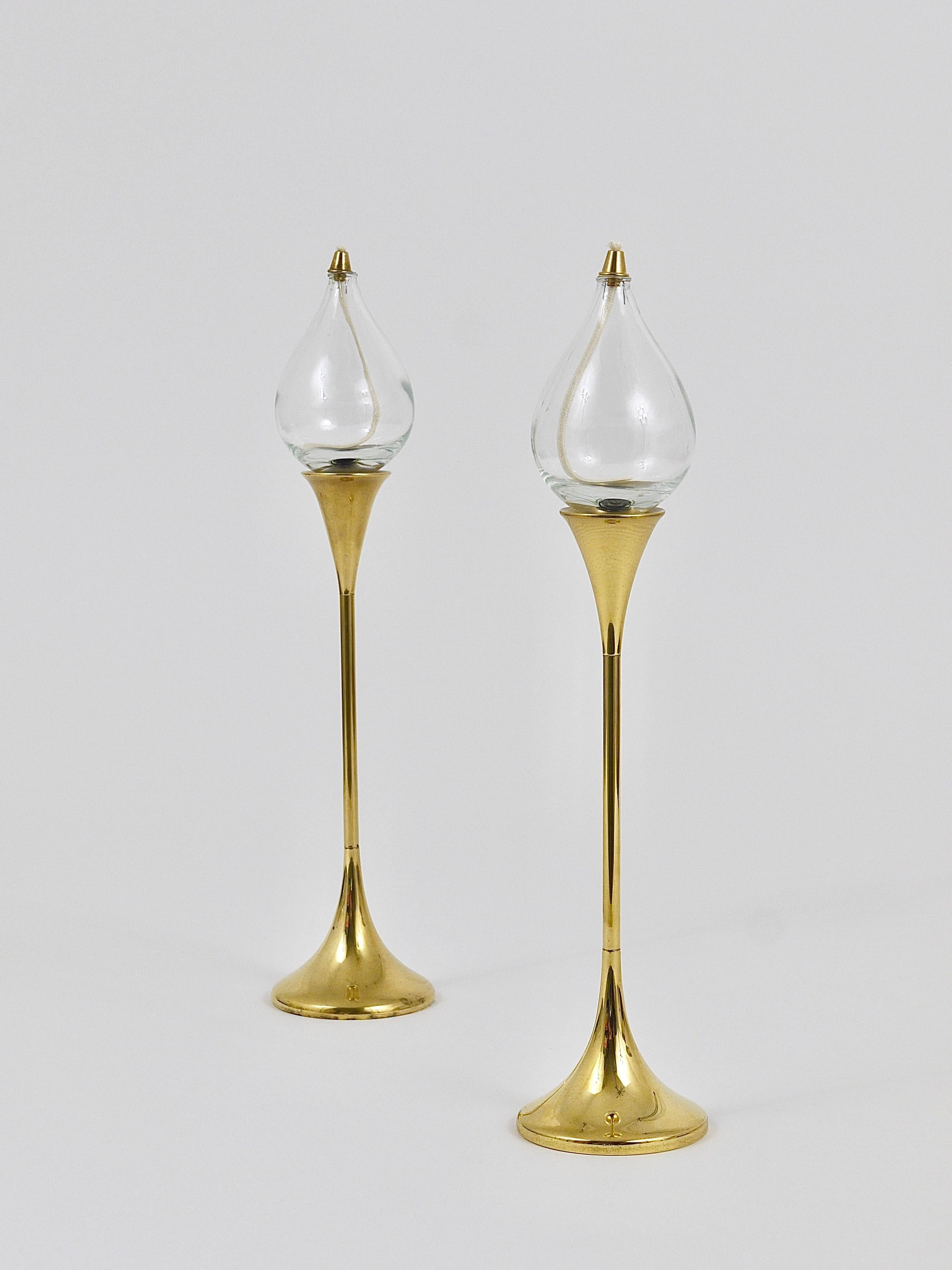 Two beautiful 14 in high modernist brass oil lamp candlesticks, designed by Freddie Andersen, made in Western Germany in the 1970s. In very good condition. Two candleholders are available, sold and priced per piece.