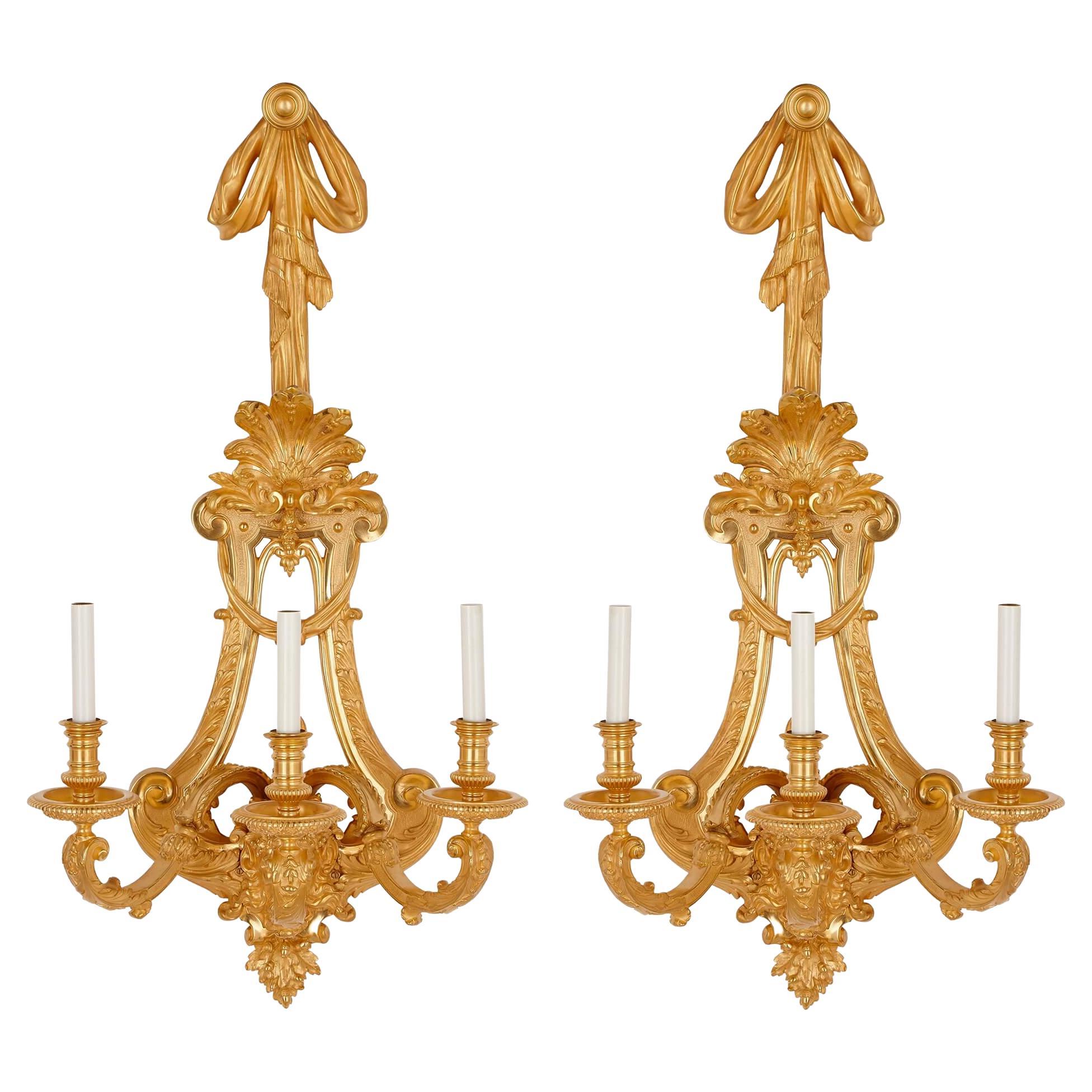 Two large French ormolu three-branch wall sconces by H. Vian For Sale