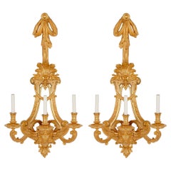 Two large French ormolu three-branch wall sconces by H. Vian