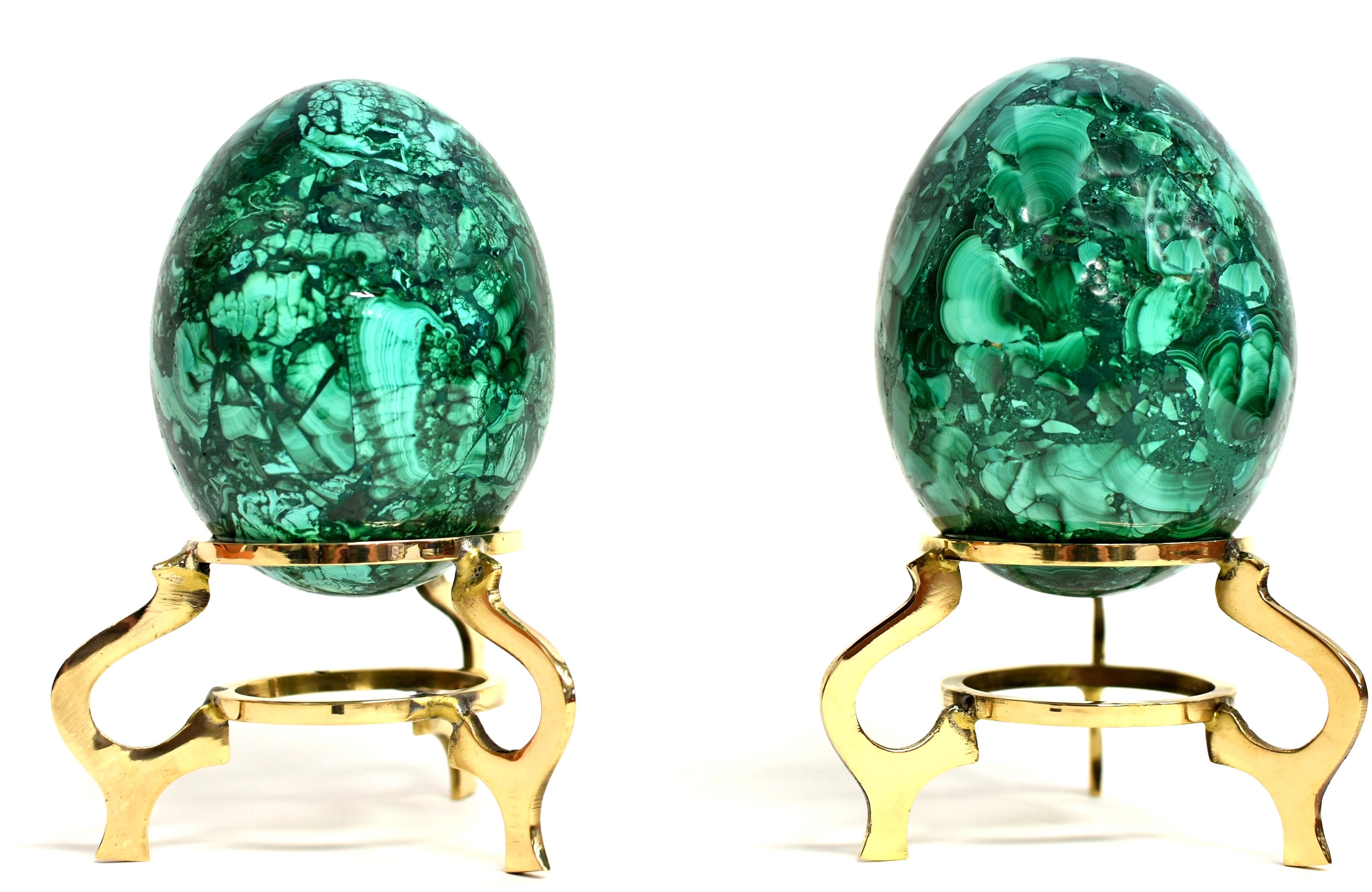 Set of two splendid malachite eggs. Hand crafted and polished, displaying fantastic various natural patterns of swirls and stripes. A stone of transformation, malachite provides balance and protection. A remarkable objet d'art of luxury and