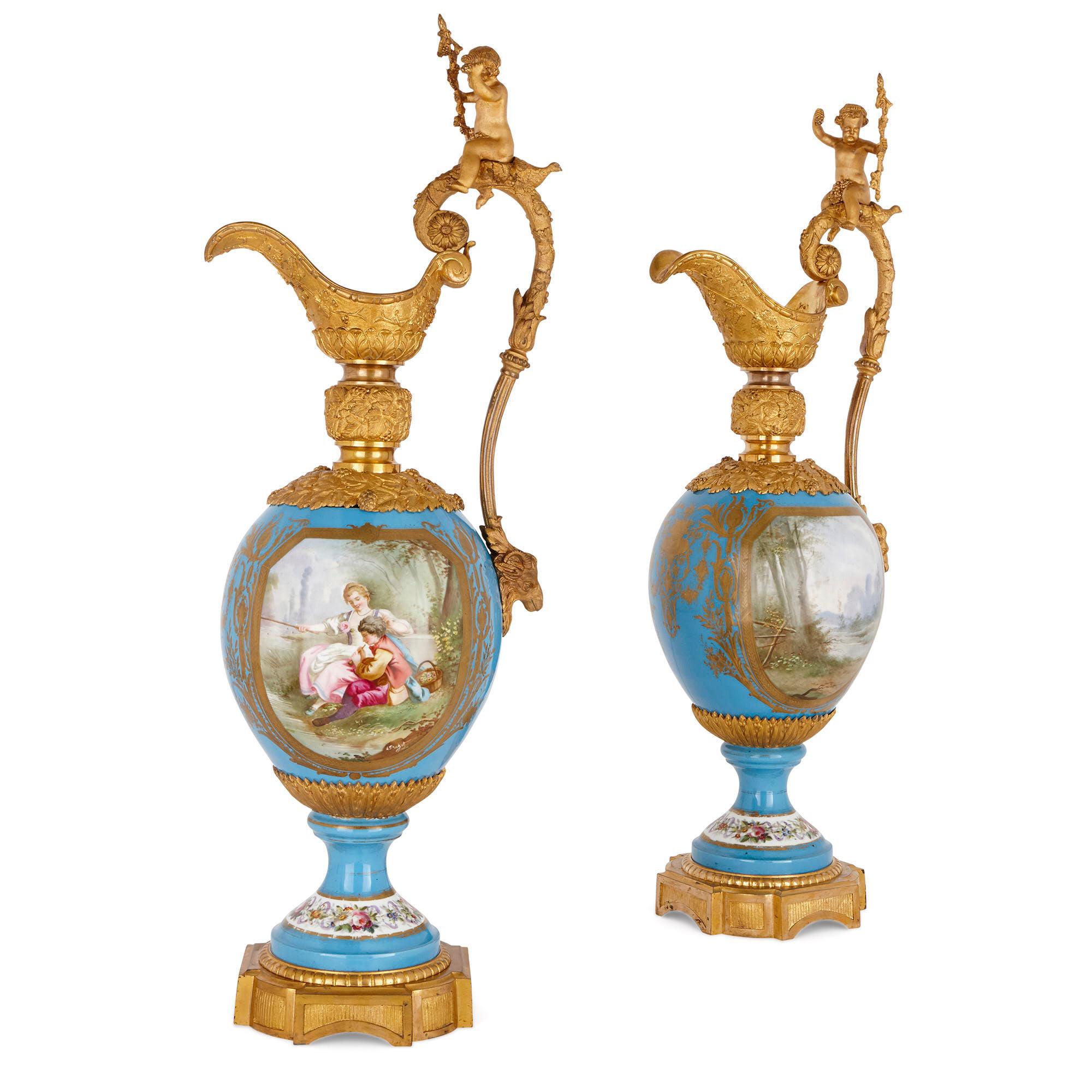 These jugs (ewers) are magnificent works of decorative art which measure an impressive 1m (39 inches) in height. In their decoration, the jugs are clearly inspired by 18th century Rococo style wares created by the Sèvres Porcelain