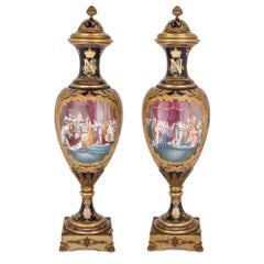 Two Large Sèvres Style Gilt Bronze Mounted Porcelain Vases on Walnut Plinths